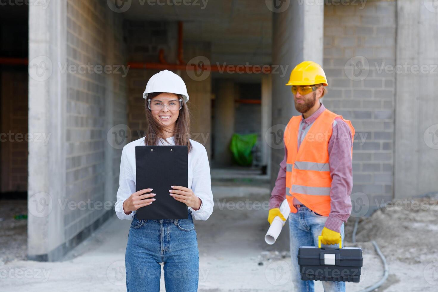 Construction engineers discussing building project at construction site photo