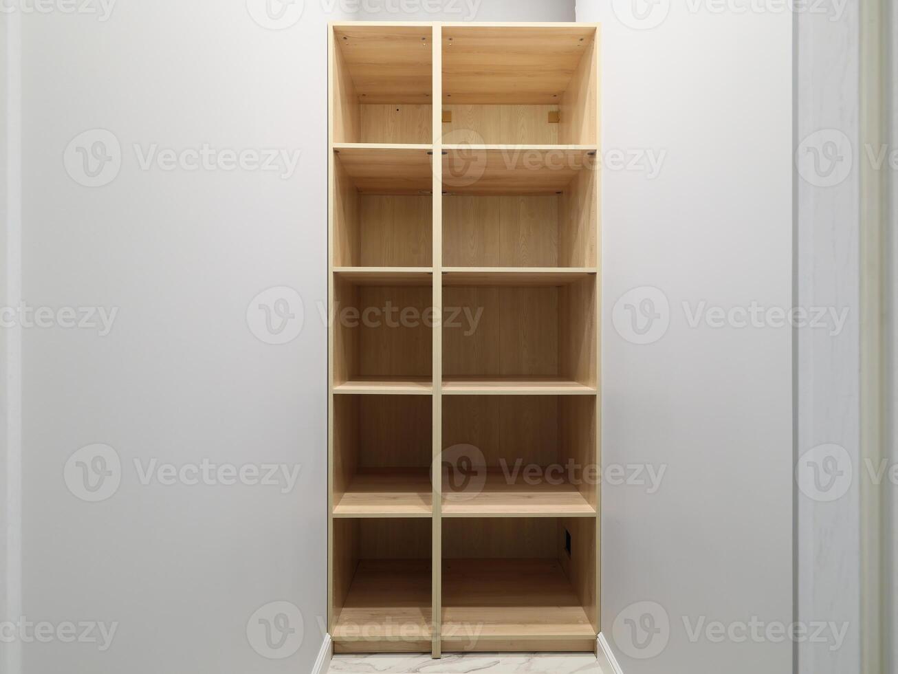 A Simple Wooden Shelf Unit featuring Compartments designed specifically for Storage purposes photo