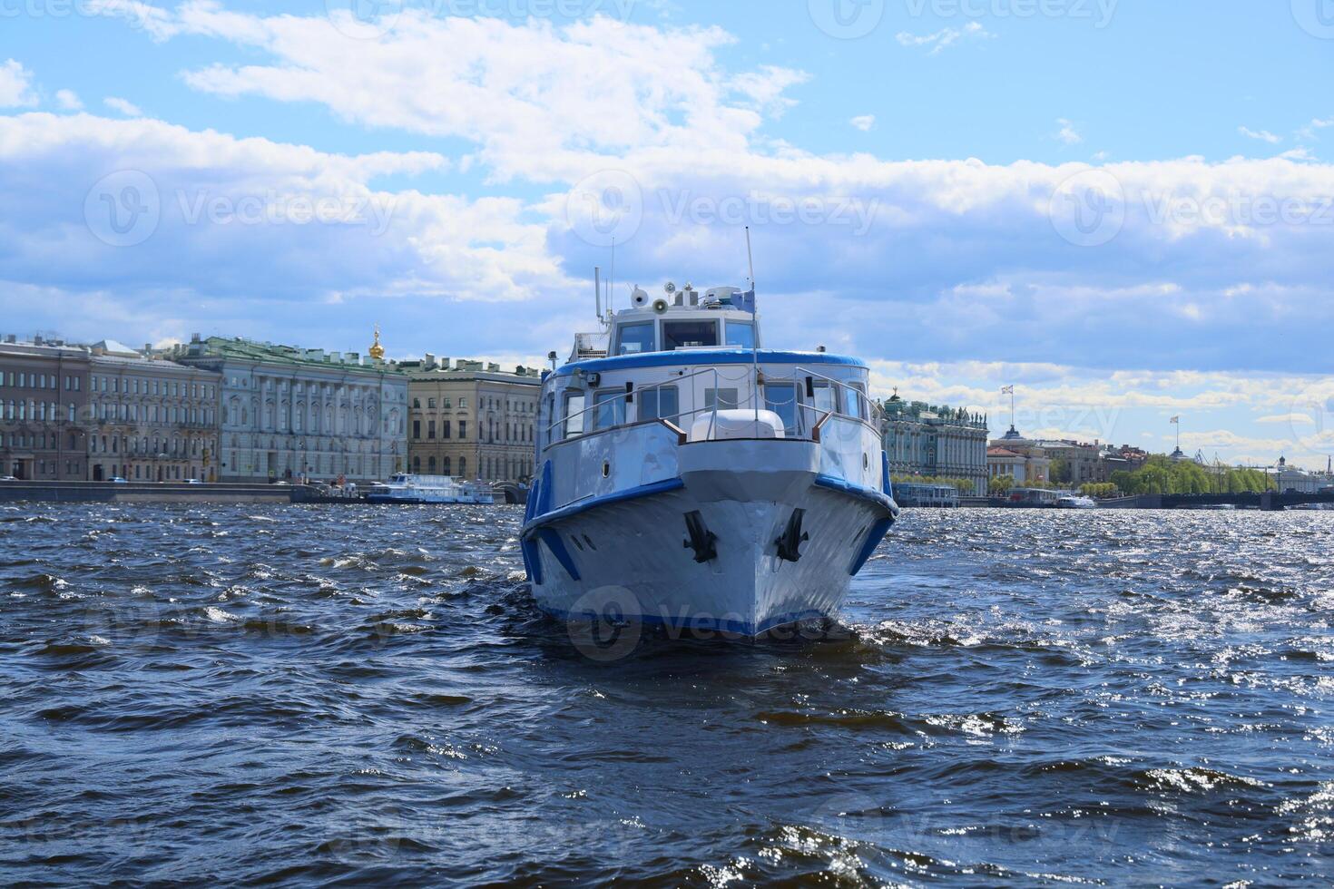 Enjoy a scenic riverboat ride on a sunny day in the vibrant city with stunning architecture photo