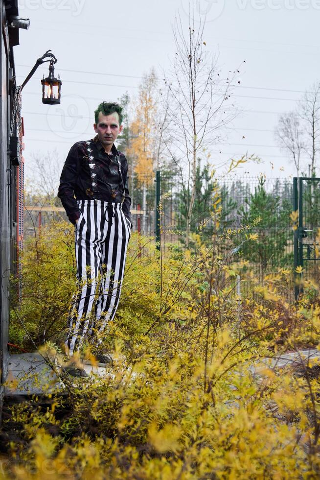 A Stylish Character Dressed in Trendy Striped Pants, Surrounded by Beautiful Autumn Colors photo