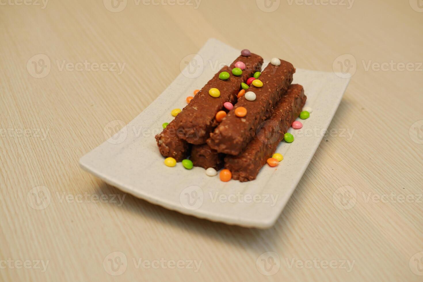 Chocolate Bars with Colorful Sprinkles on a White Plate photo