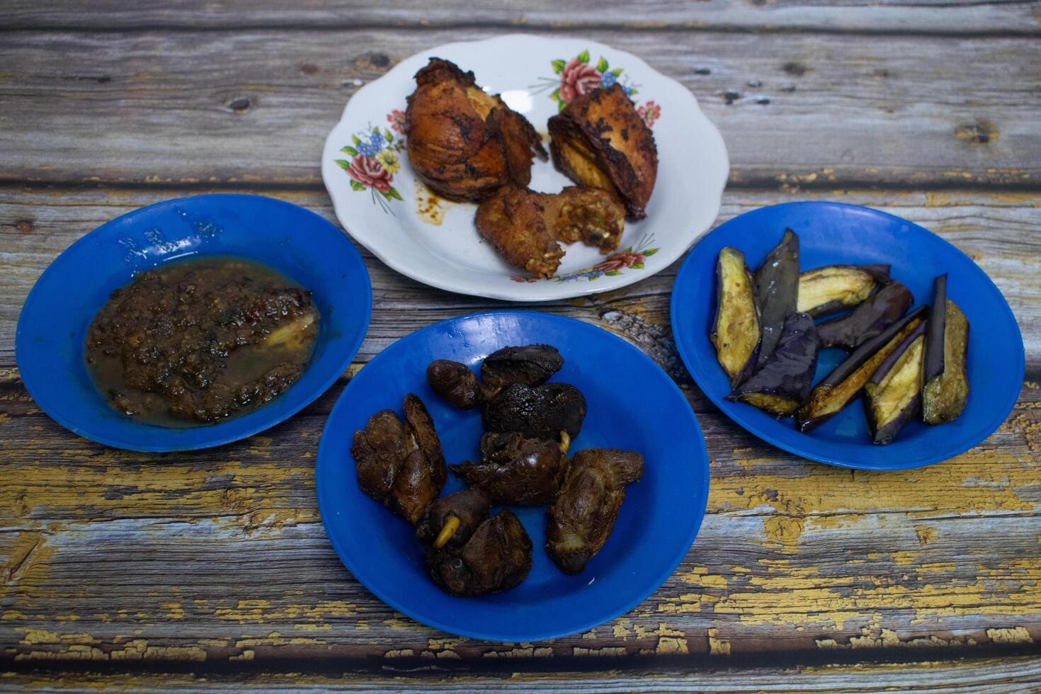 Serving authentic home-cooked dishes with a combination of fried chicken, fried chicken liver, eggplant, and chili sauce. photo