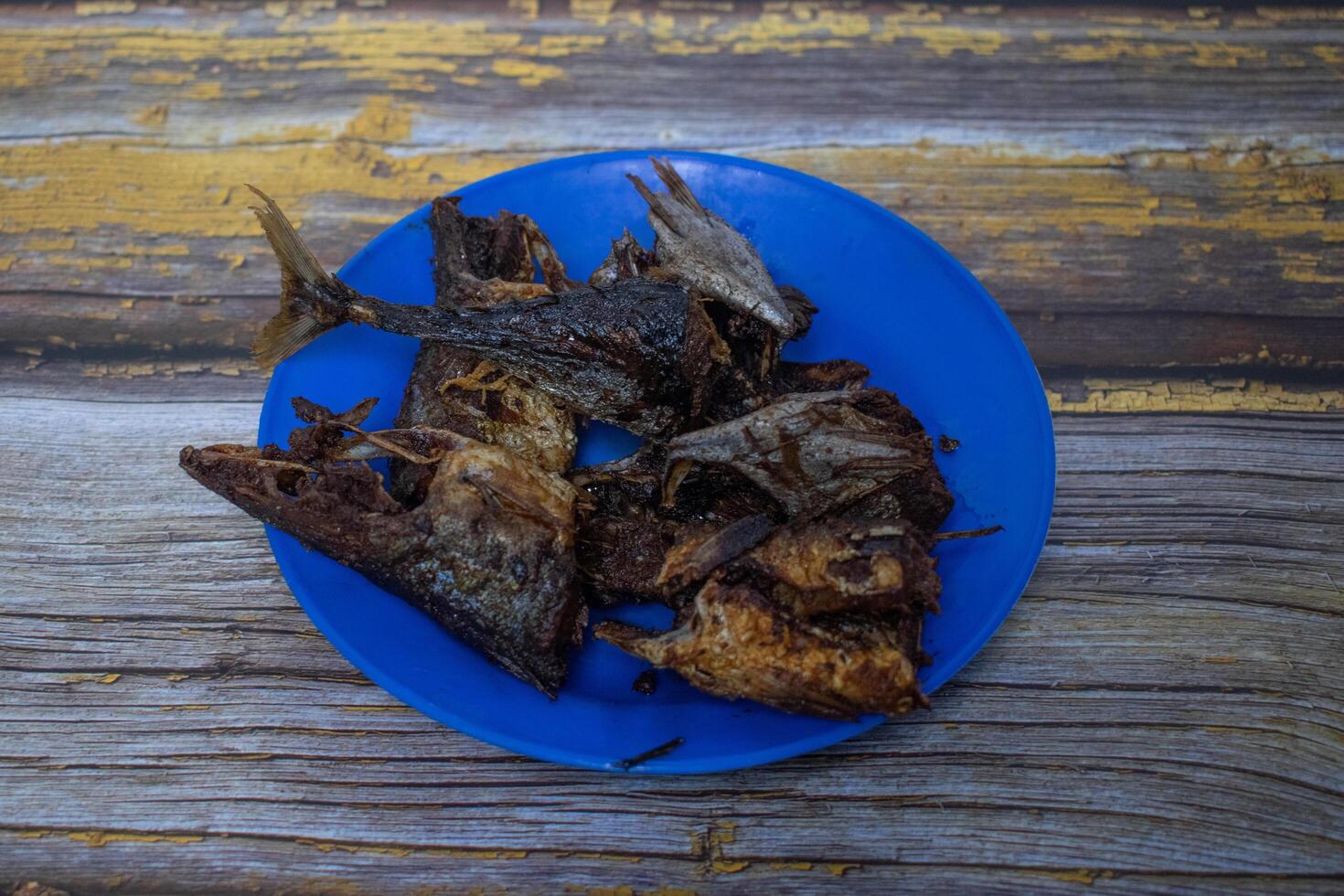 Crispy fried fish pieces displayed on a blue plate, ready to be enjoyed as a savory dish photo