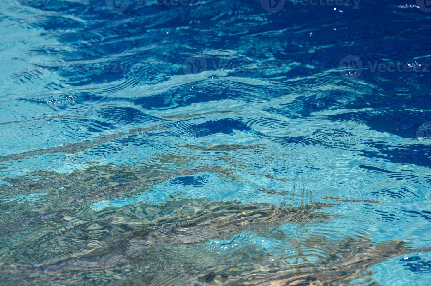 Sunlit Blue Pool Water Texture, Close-Up Abstract View photo