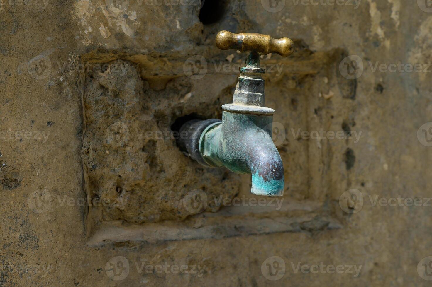 Old Bronze Water Tap in Outdoor Washbasin in Cyprus photo