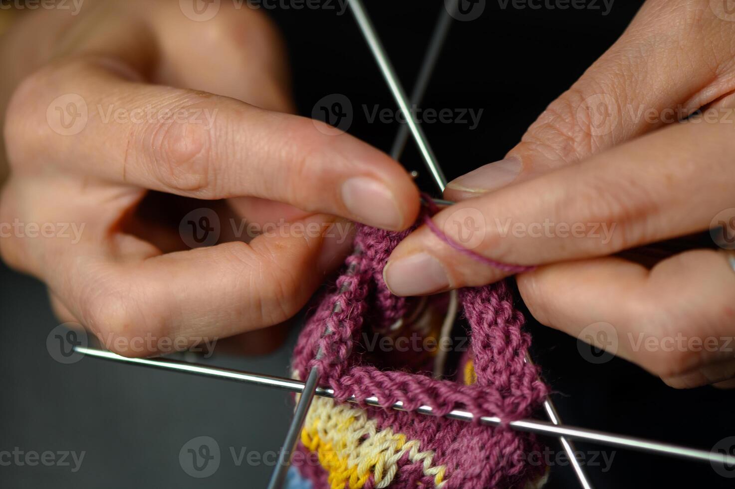 Female Hands Knitting Colorful Socks in Natural Light photo