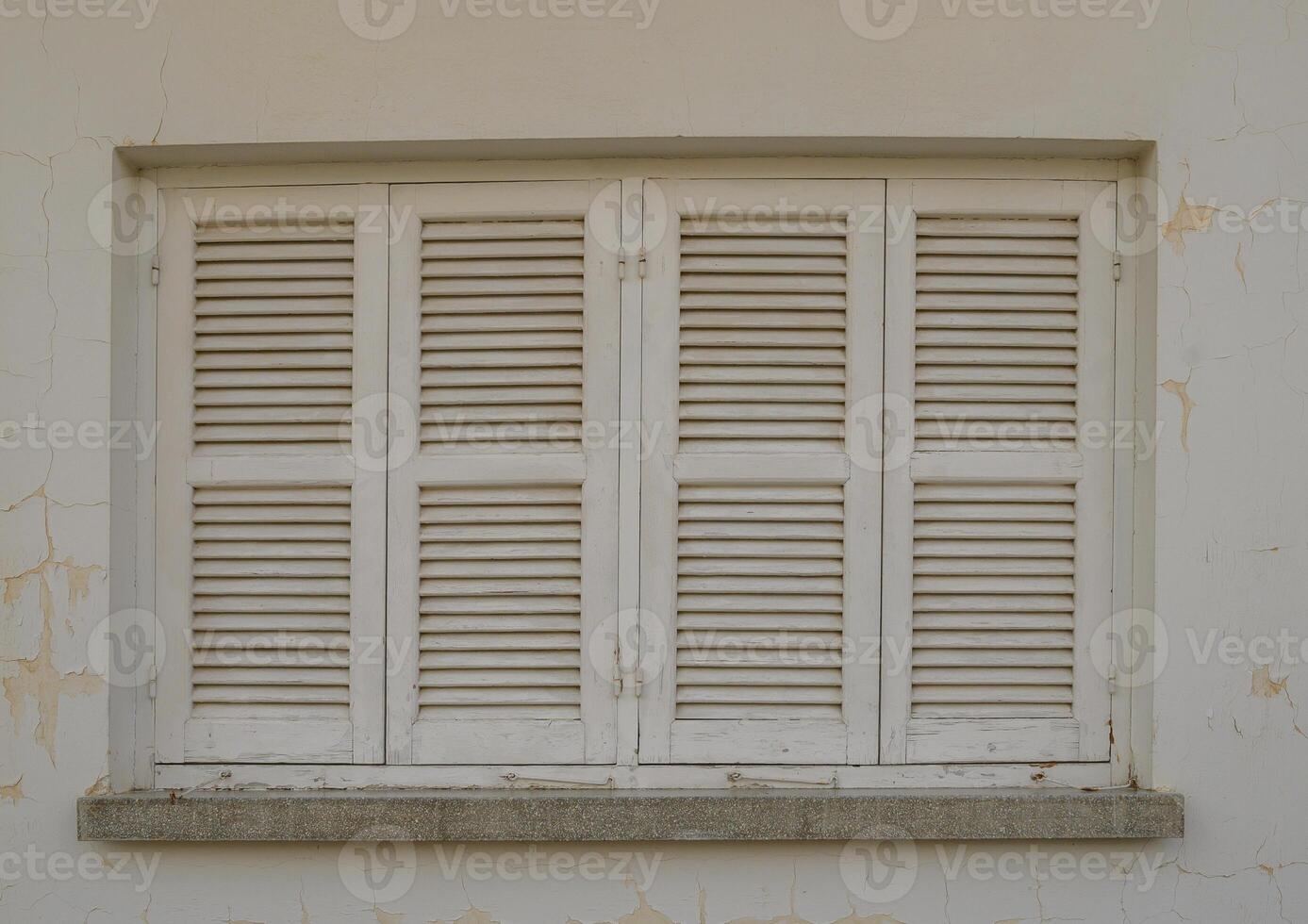 White Window with Wooden Shutters on Traditional Cyprus House photo