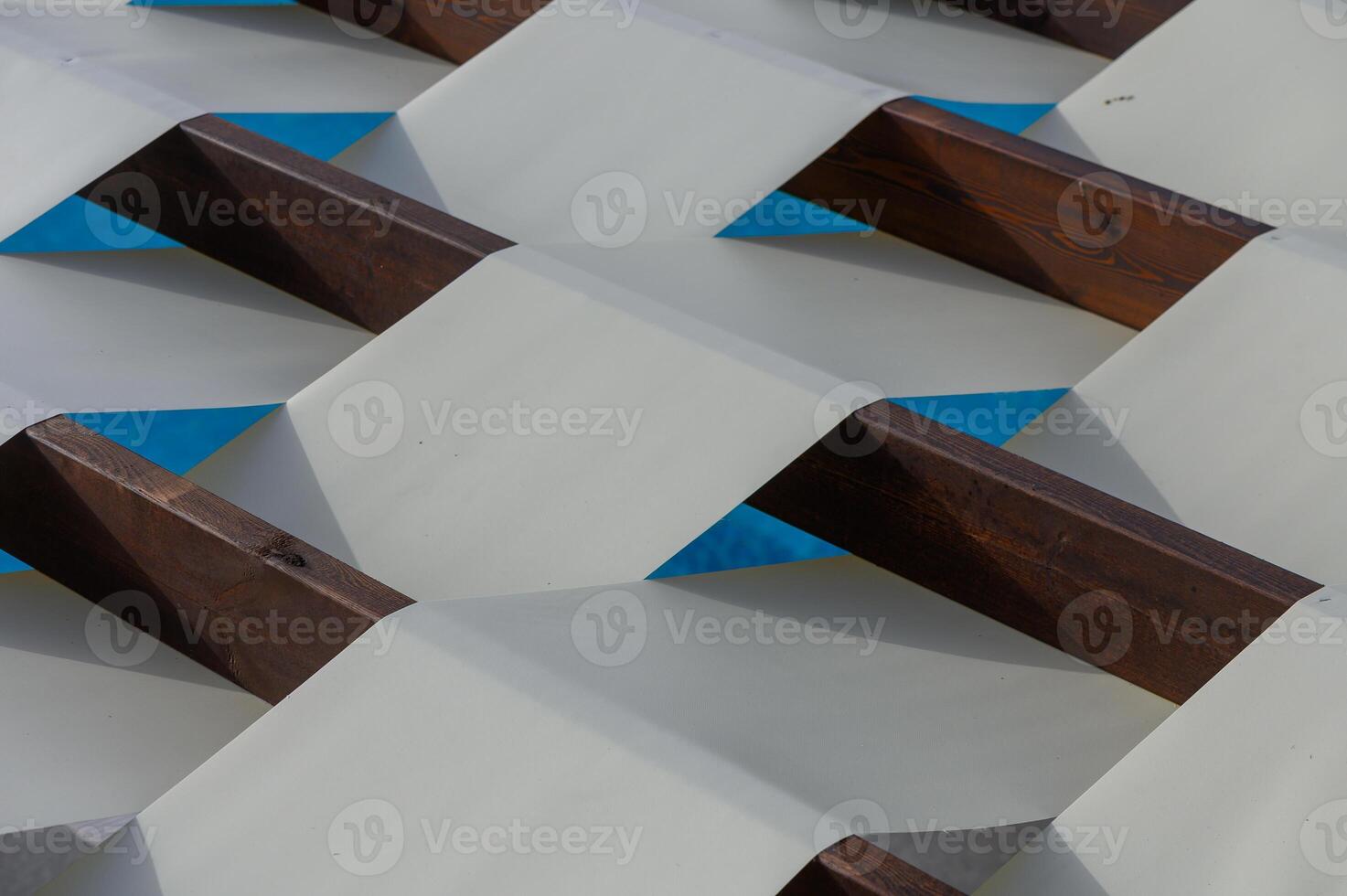 Bright white lines of sunlight pass through wooden planks, creating graphic abstract pattern on roof. photo