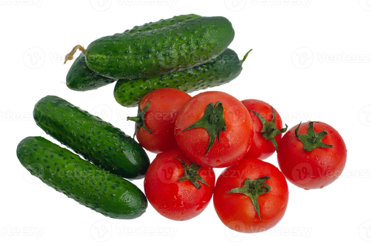 Tomatoes and cucumbers isolate on white. Vegetables red tomatoes and green cucumbers. photo