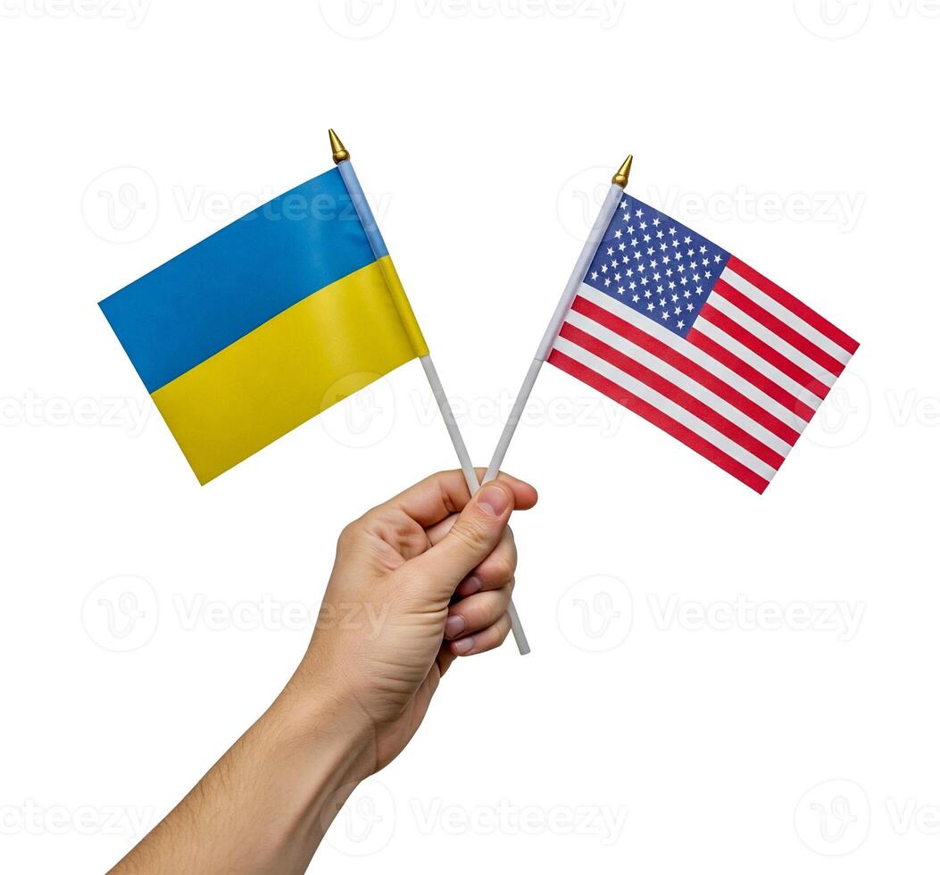Hand holding Ukraine and USA flags together, international partnership and support concept, diplomatic relations, copy space on white background photo