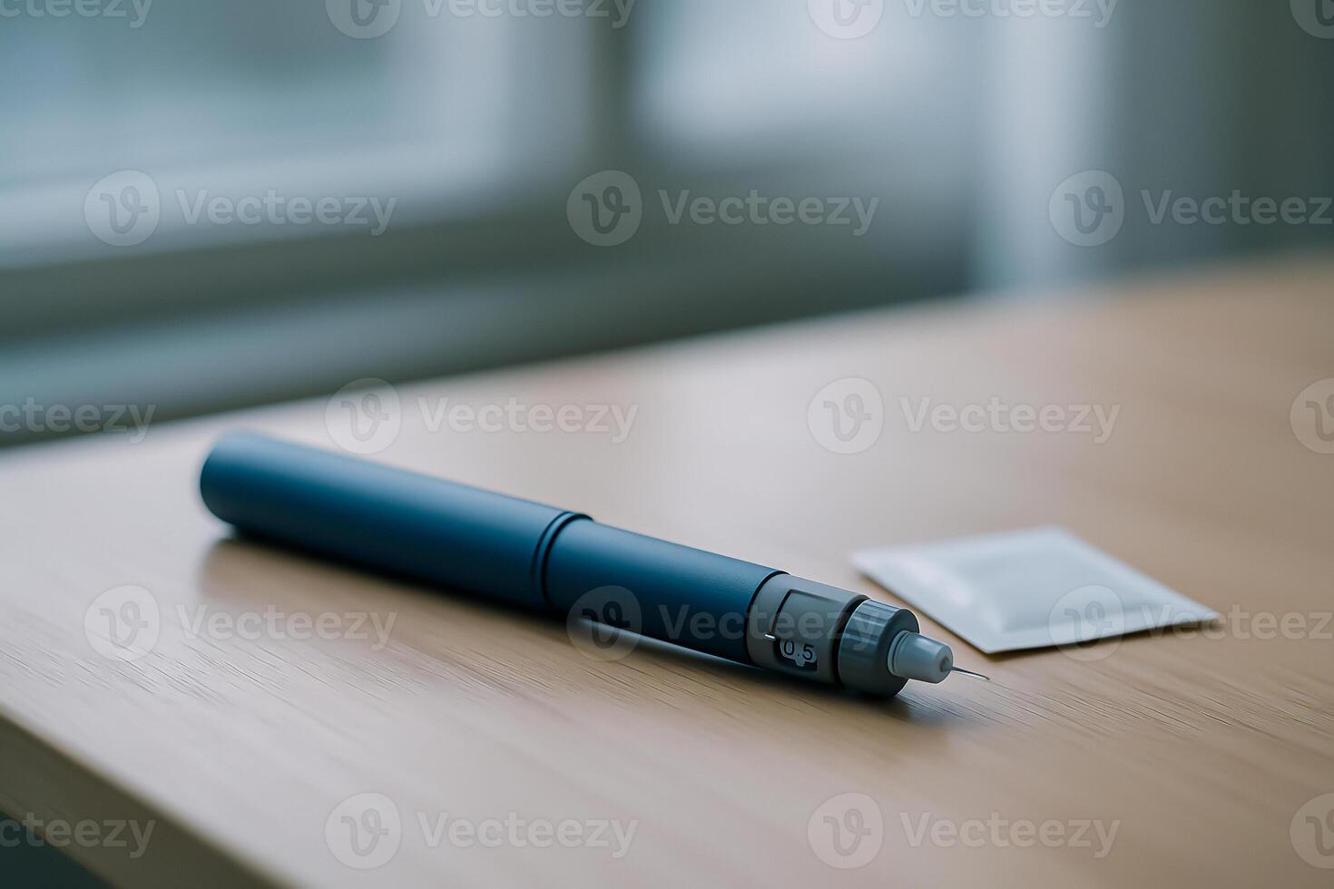 Insulin pen injector on wooden desk with single-use alcohol swab, diabetes self-care product, personal medication device photo