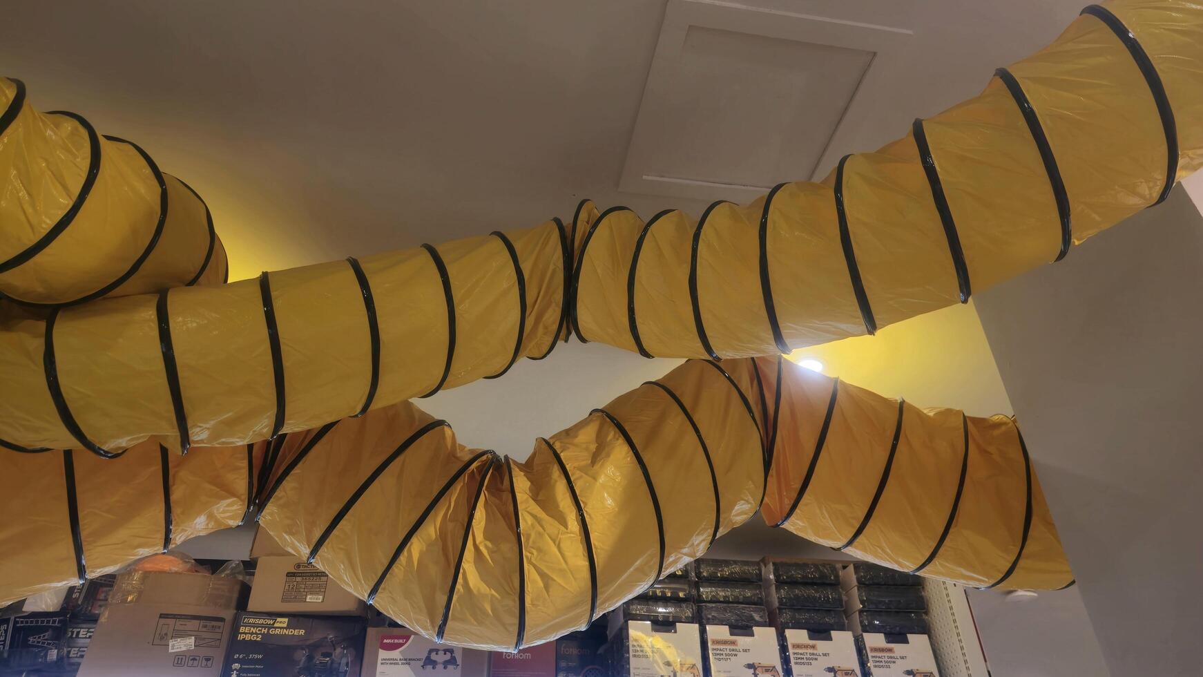 Yellow Flexible Duct Suspended From Ceiling photo