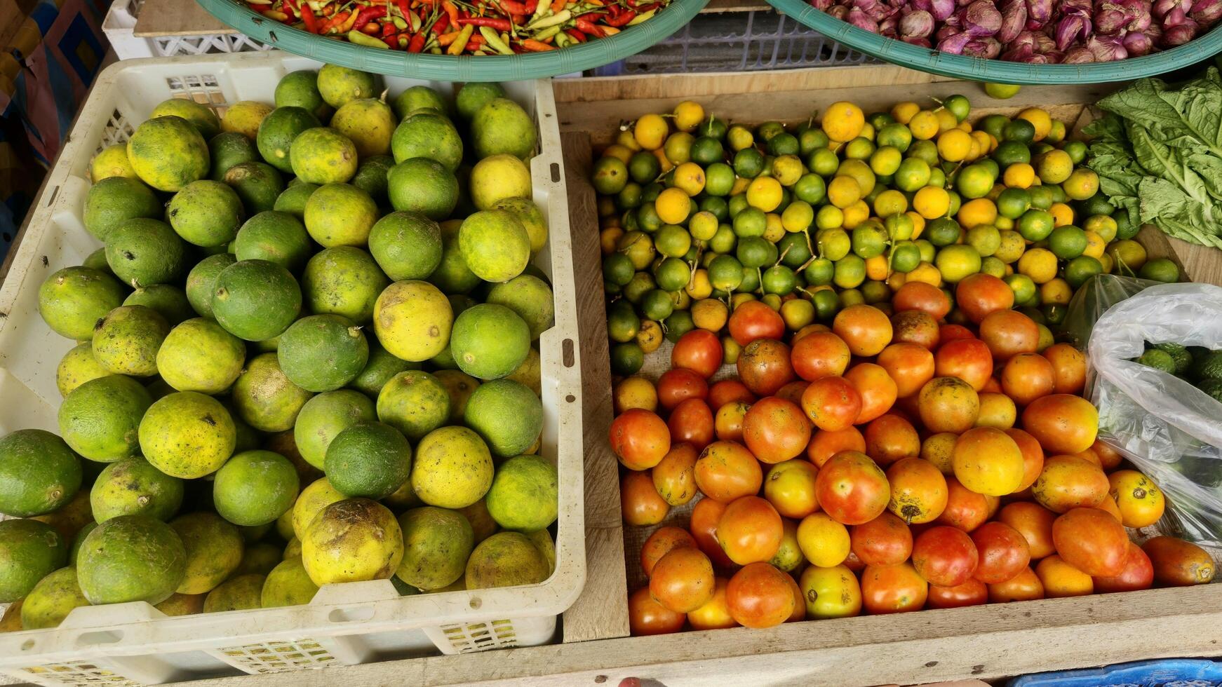 Fresh Produce at Market Limes Tomatoes Peppers Onions photo