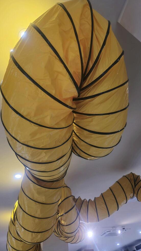 Yellow Flexible Duct Hanging From Ceiling photo