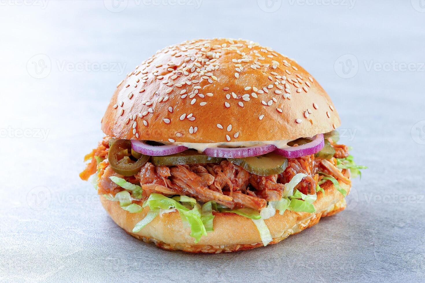 Juicy Pulled Pork Sandwich Layered with Fresh Lettuce and Pickles photo