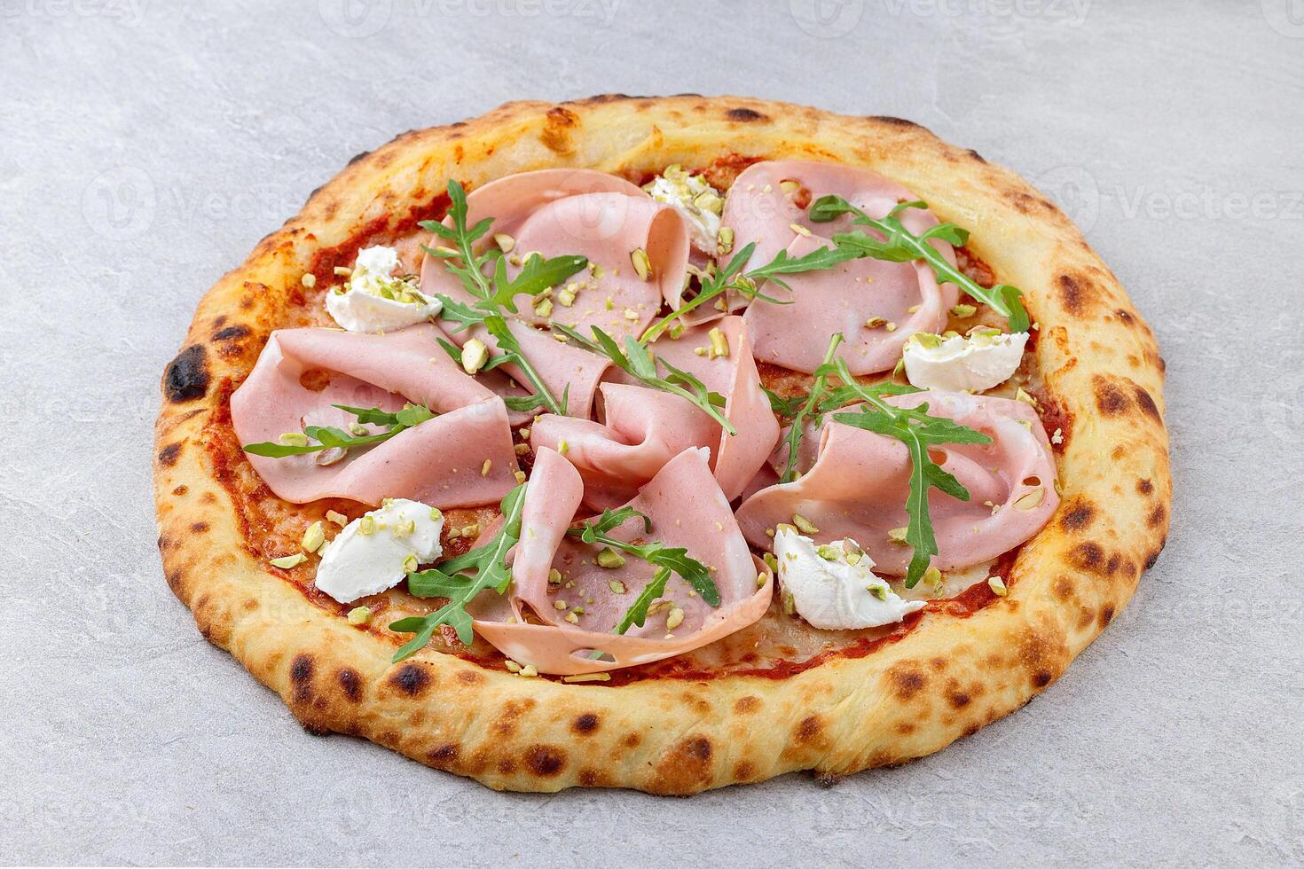 Overhead View of Neapolitan Pizza with Mortadella, Ricotta, Arugula and Pistachios photo