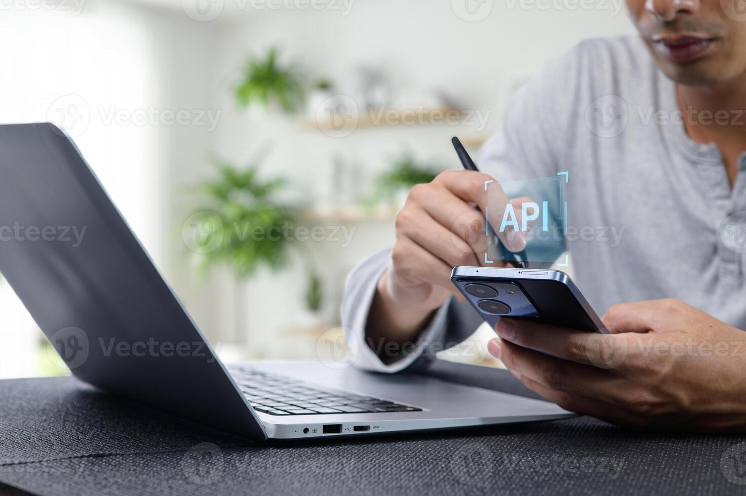 Programmer Working on API Development with Laptop and Smartphone photo