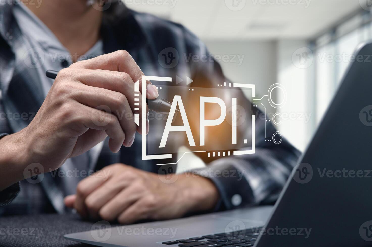 Person Programming API Interface on Laptop with Digital Overlay photo