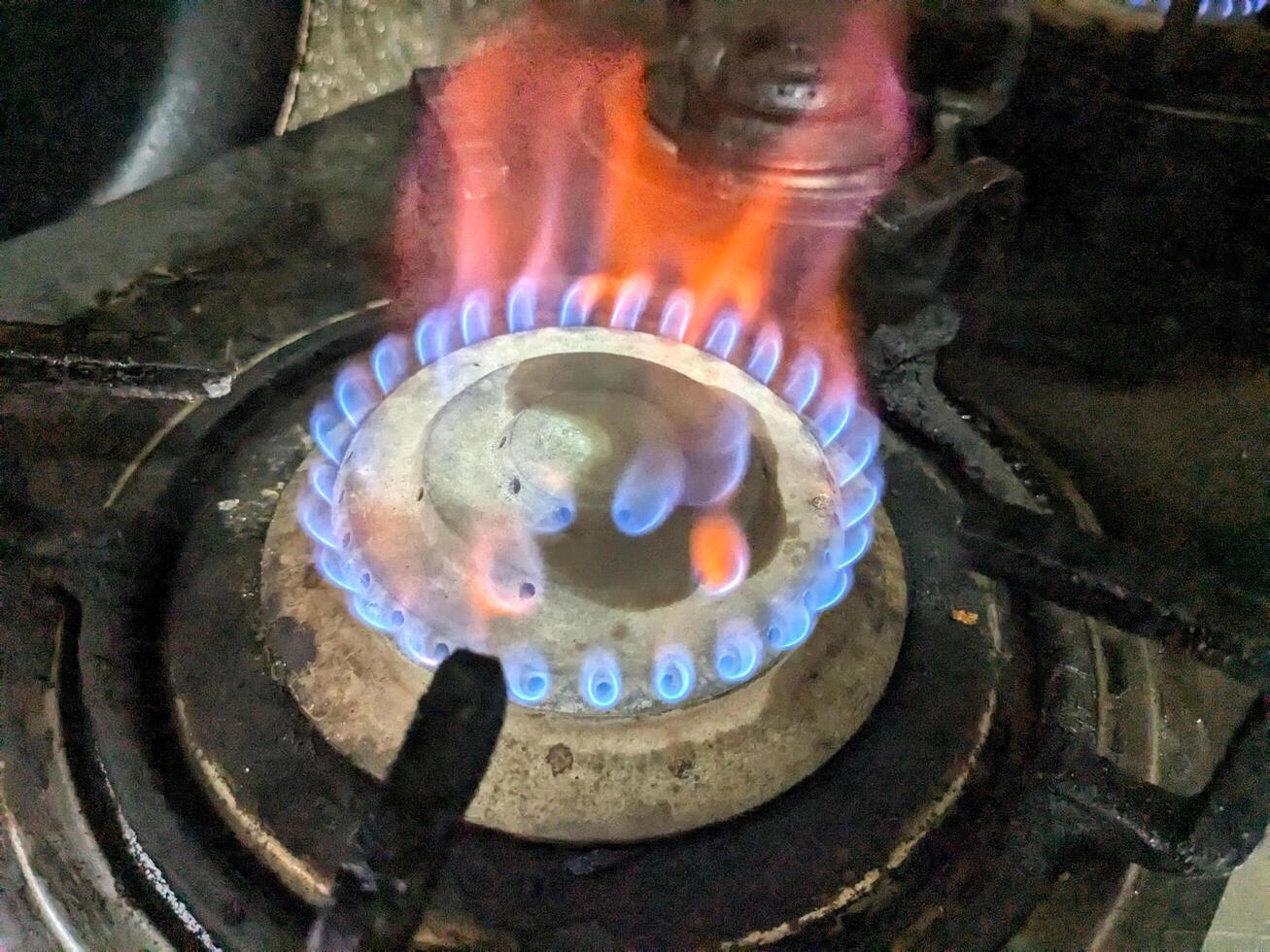 Gas burning in a kitchen gas stove top view photo