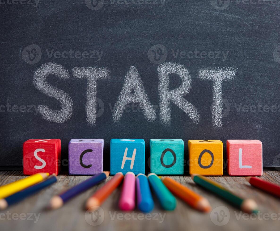 Colorful school supplies with 'Start School' on a chalkboard. photo
