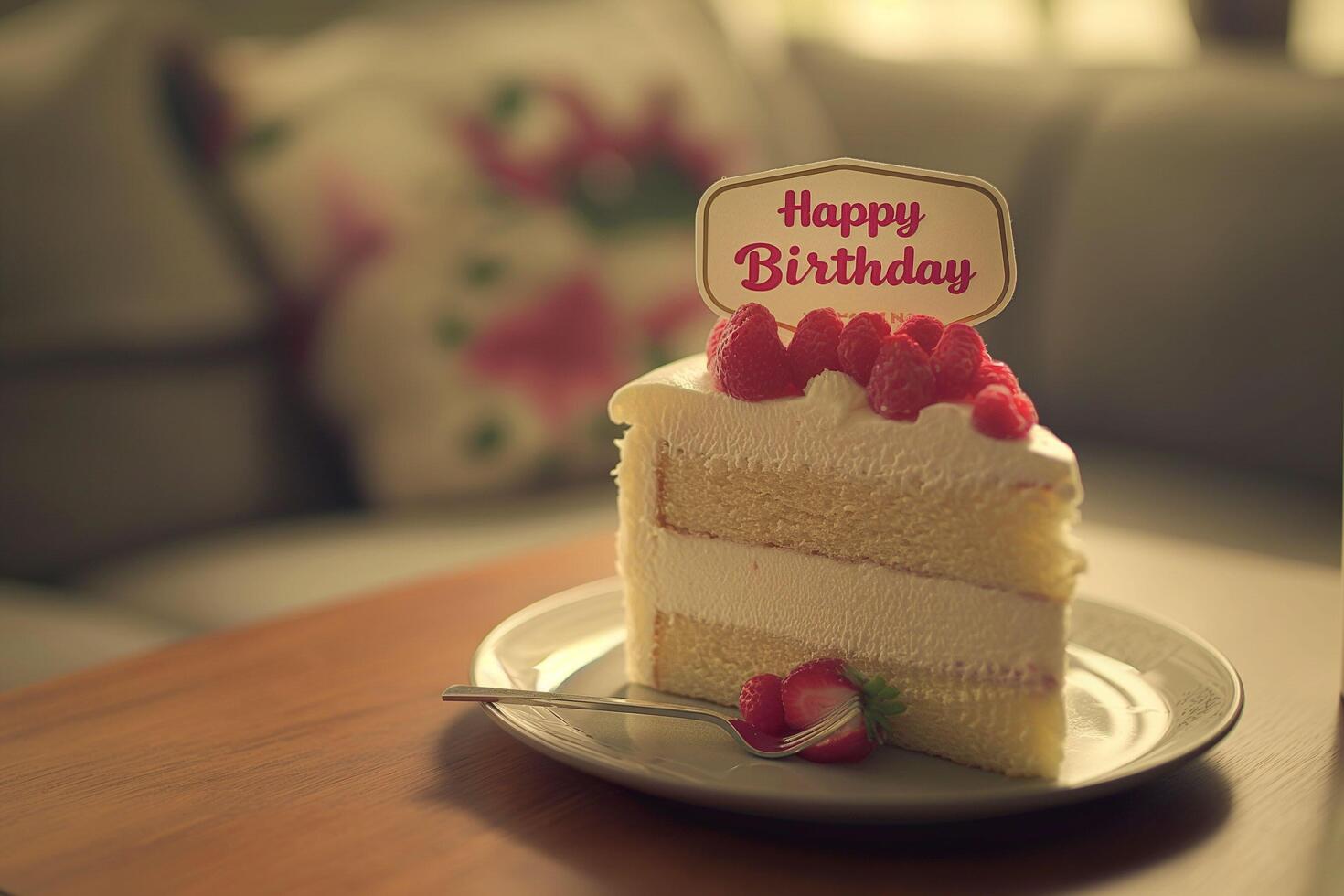 Slice of white cake with a red strawberry on top photo