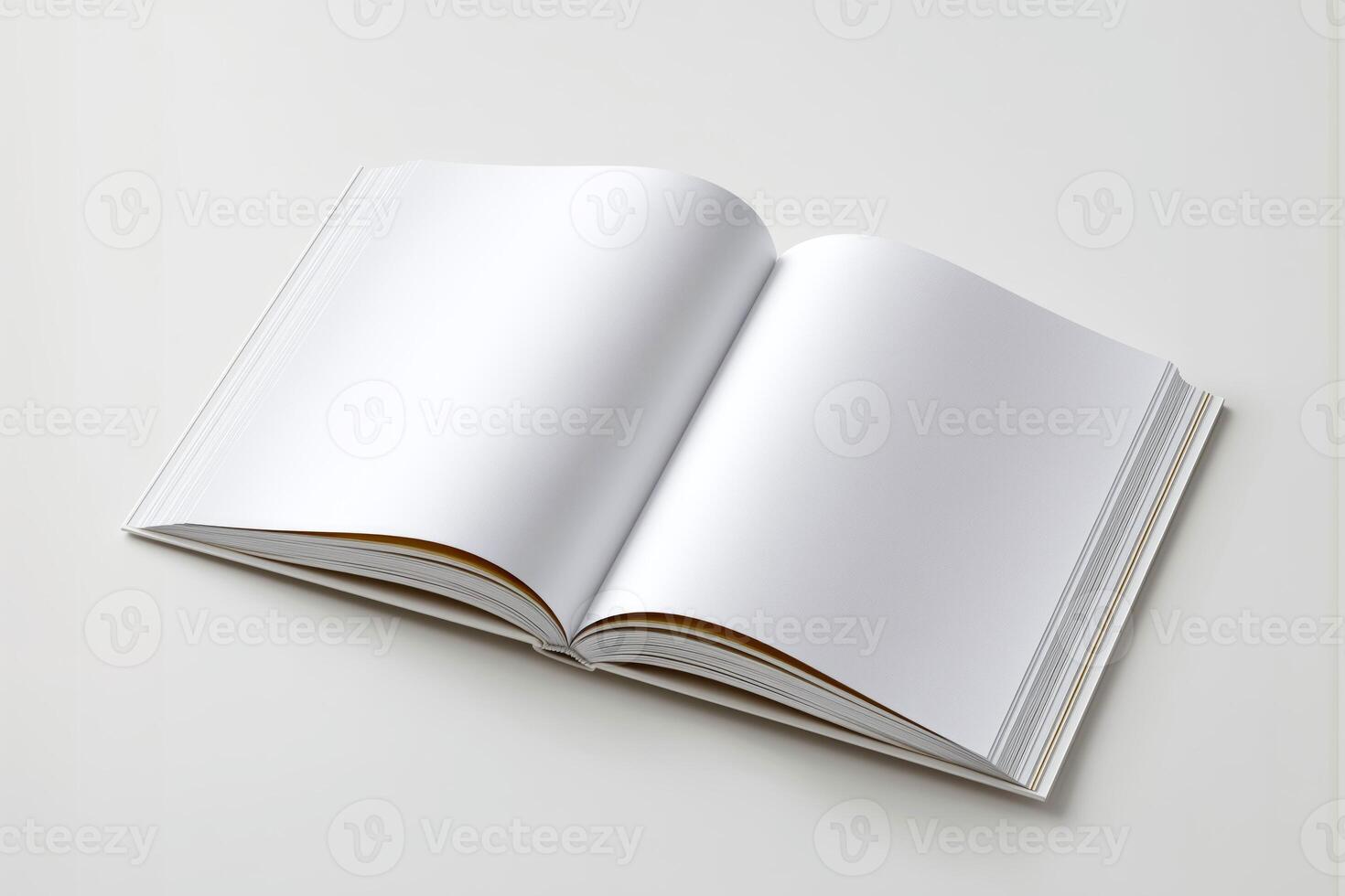 Open blank book on a white table, ready for writing or sketching. photo