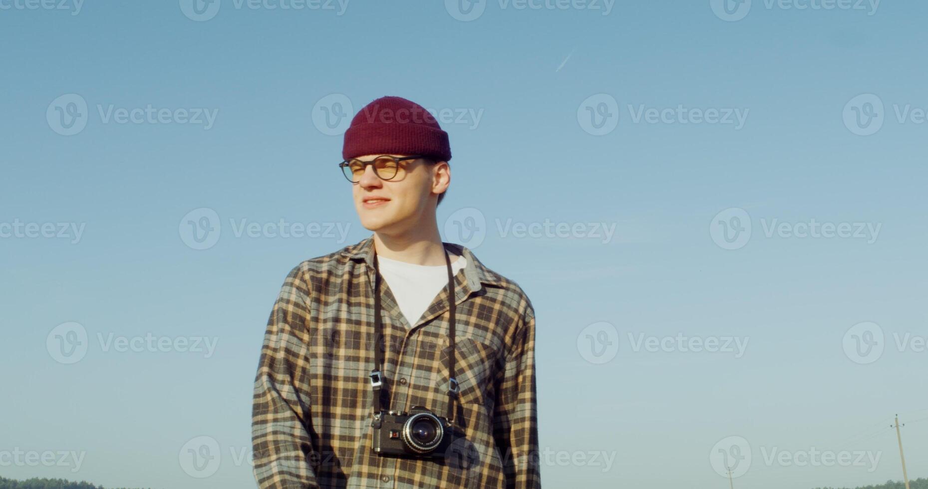 A male photographer walks through a picturesque countryside looking for photo inspiration. 4k , red komodo