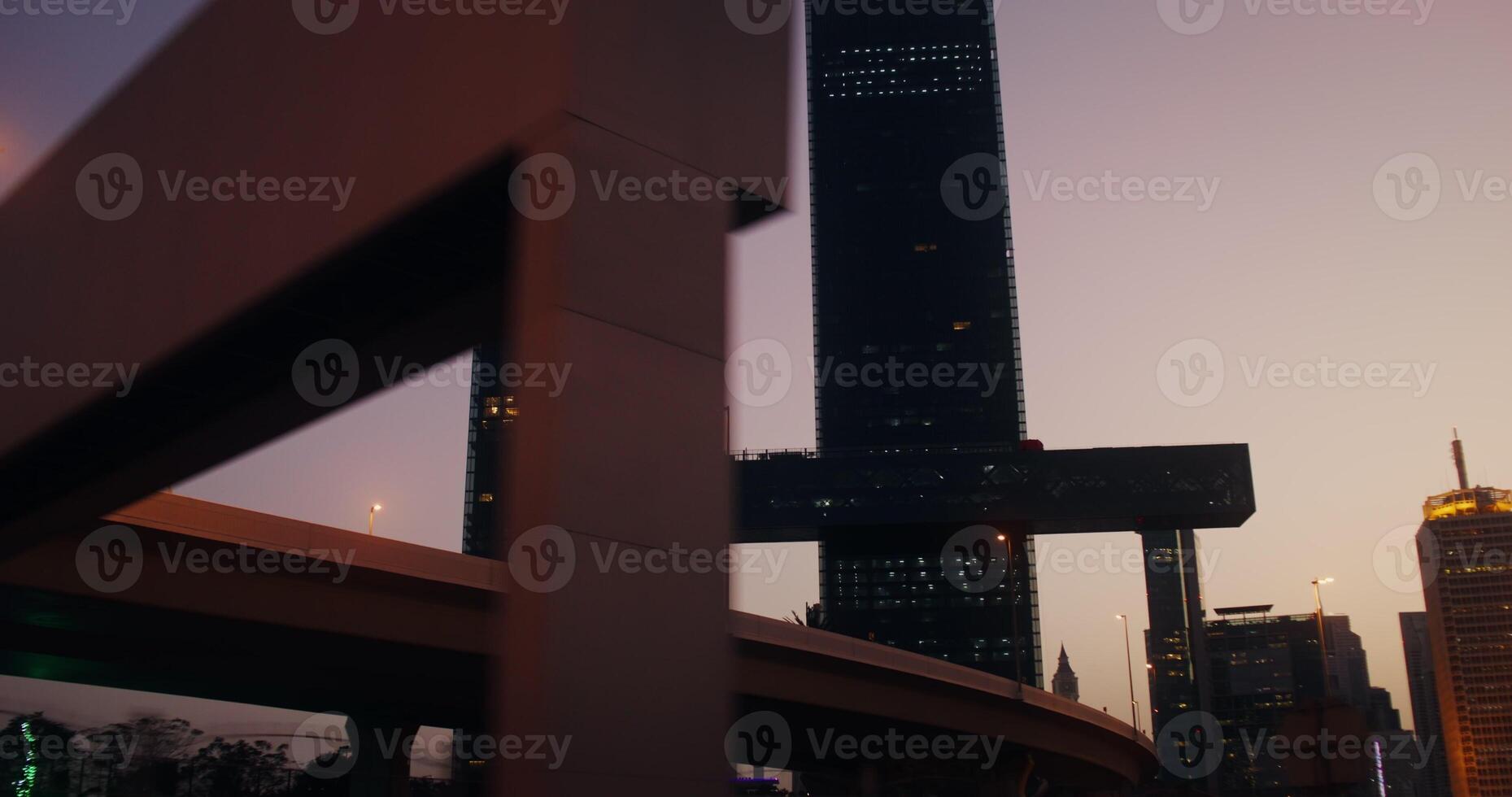A view of skyscrapers with light in the windows in the rays of the setting sun photo