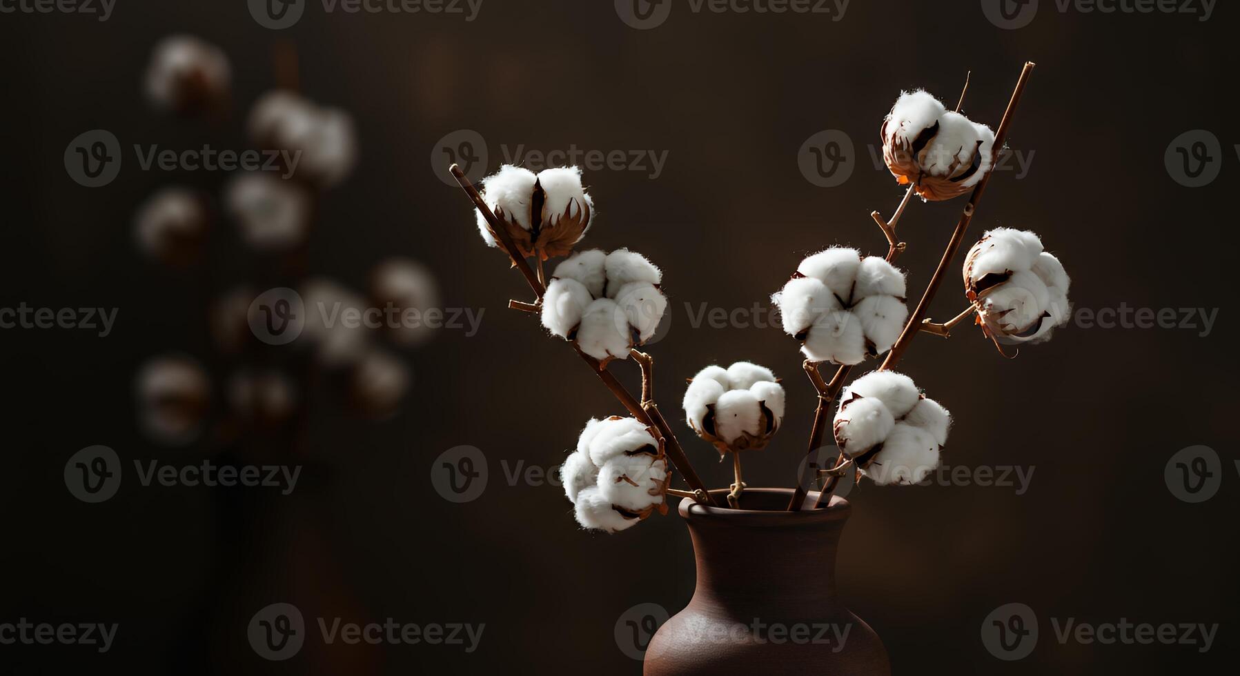 A brown vase with cotton buds in it photo
