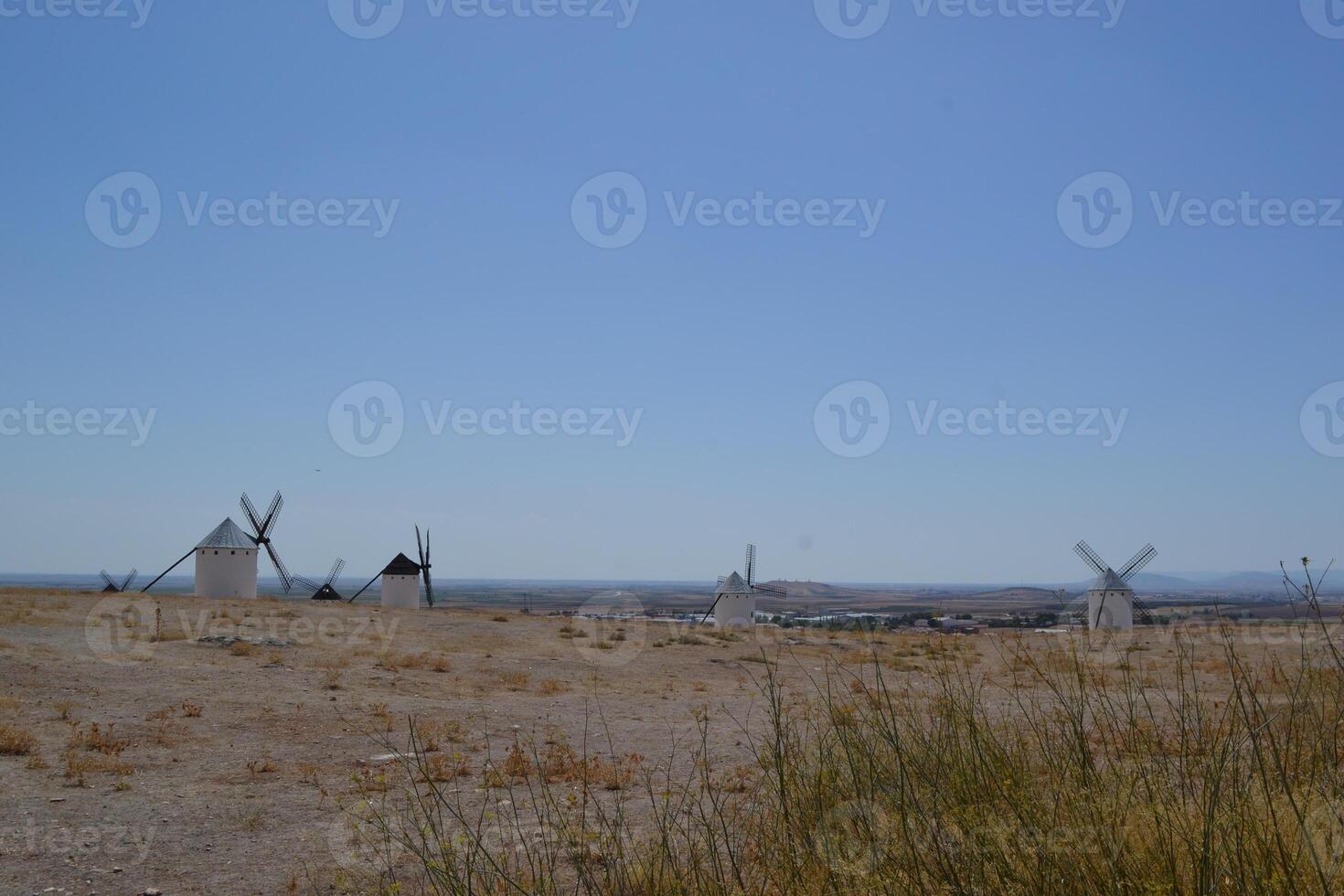 Scenic view of traditional windmills in the spanish countryside on a clear day. Campo de Criptana. La Mancha. Spain photo