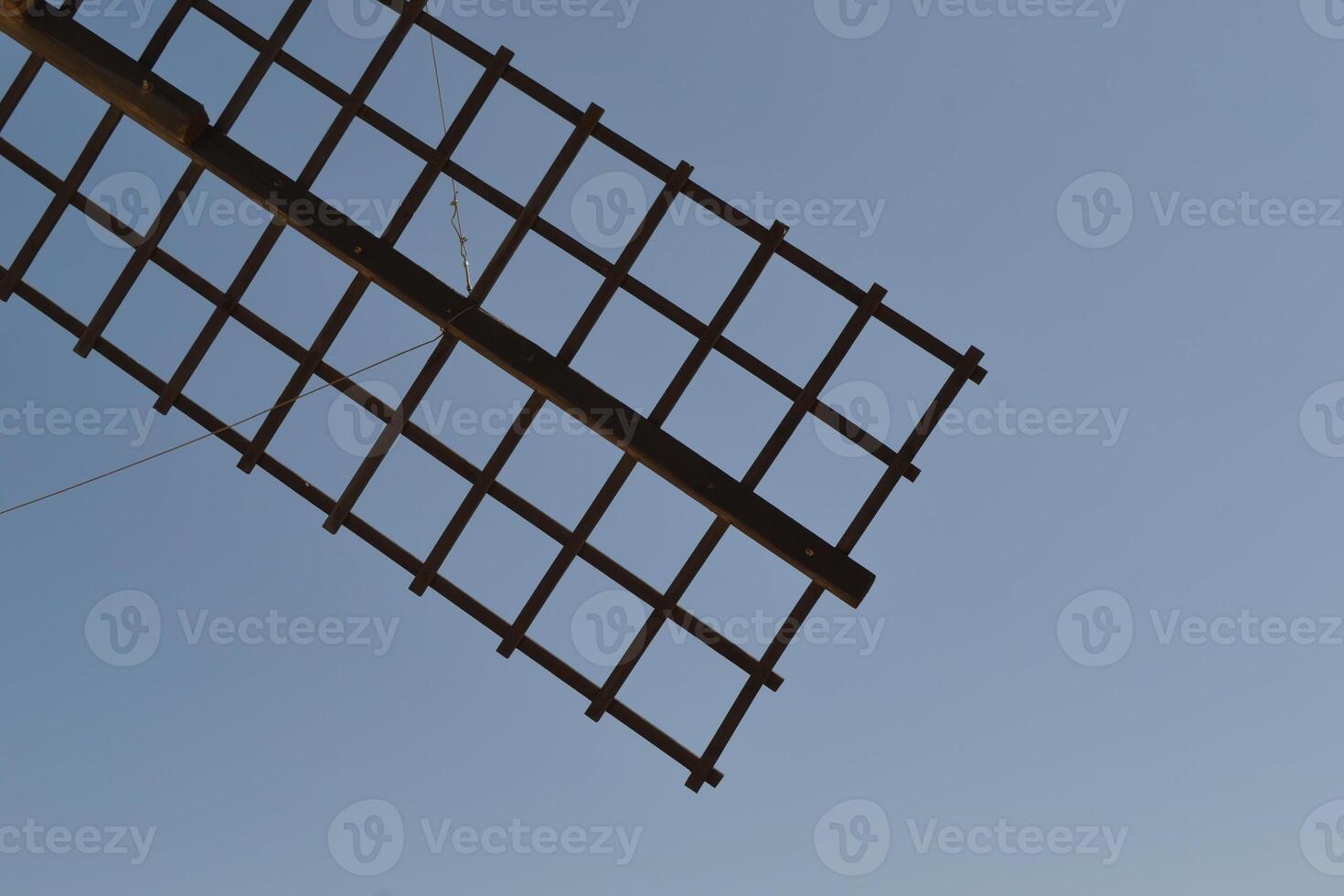 Traditional spanish windmill against clear blue sky for sustainable energy and travel design. Consuegra. La Mancha. Spain photo