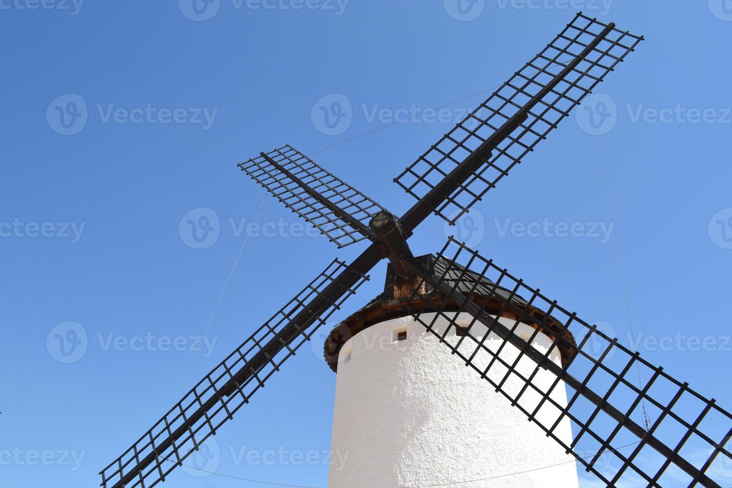 Picturesque spanish windmill against clear blue sky for travel and architecture enthusiasts. Campo de Criptana. La Mancha. Spain photo