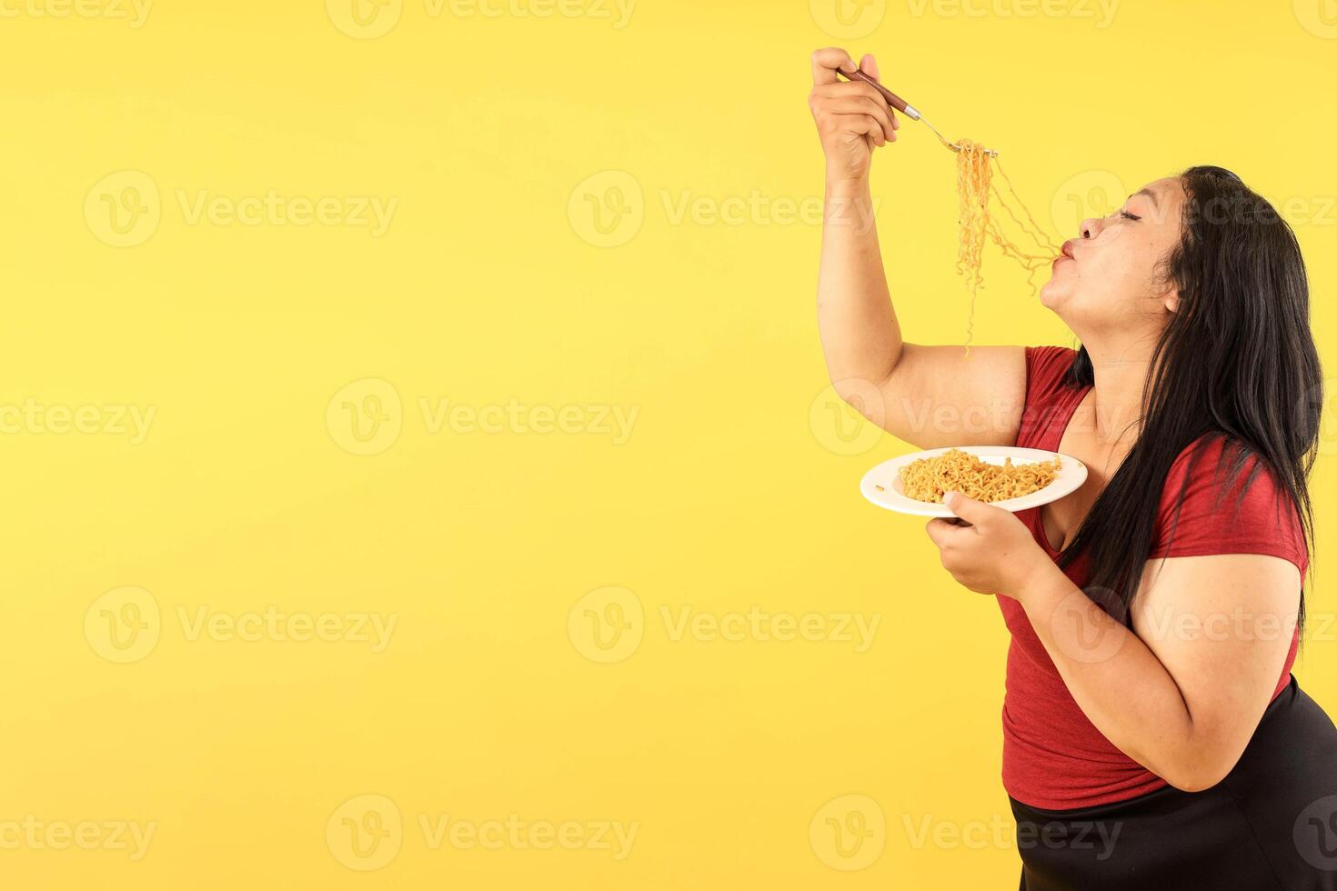 Indonesian Fat Woman Eating Indomie Goreng Instant Noodle photo
