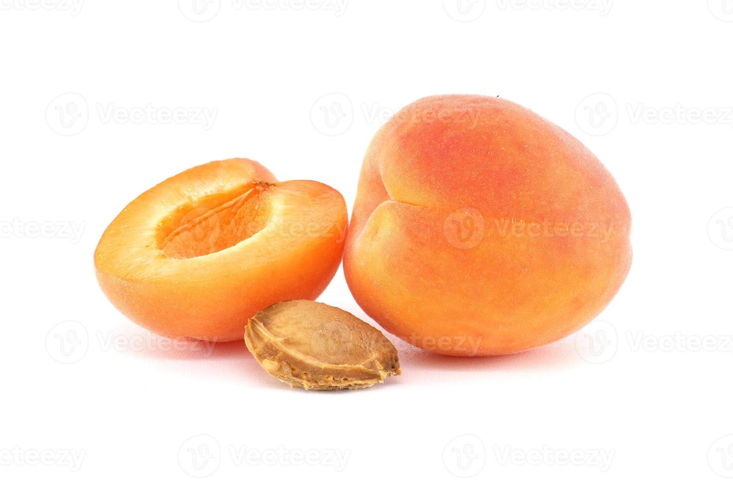 Vibrant apricots, one sliced open, showcasing a delicious and healthy fruit with a white backdrop. photo