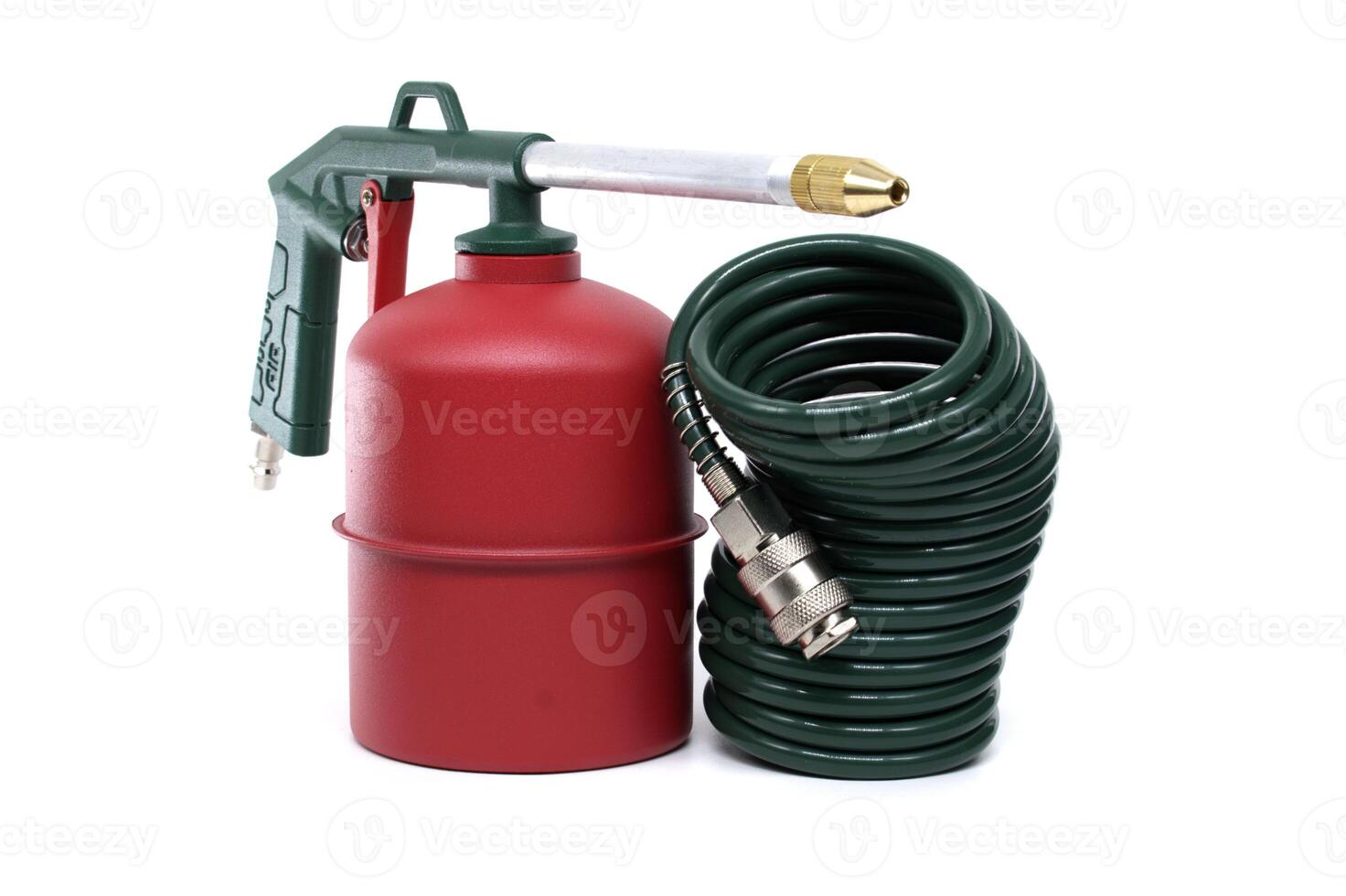 Green and Red Metal Tool with Coiled Hose on a White Background photo
