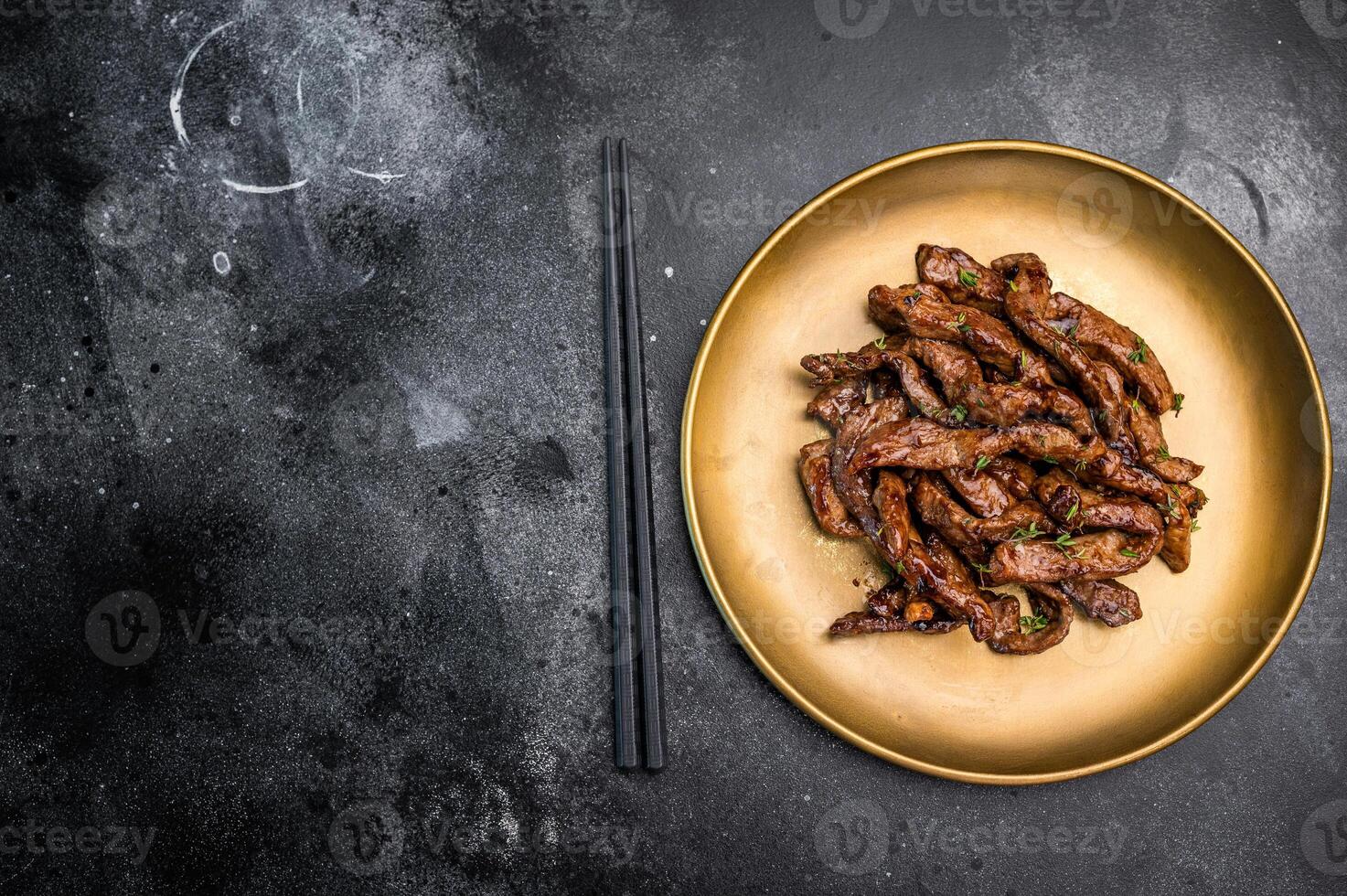 Asian food Teriyaki beef meat on a plate on black background. top view photo