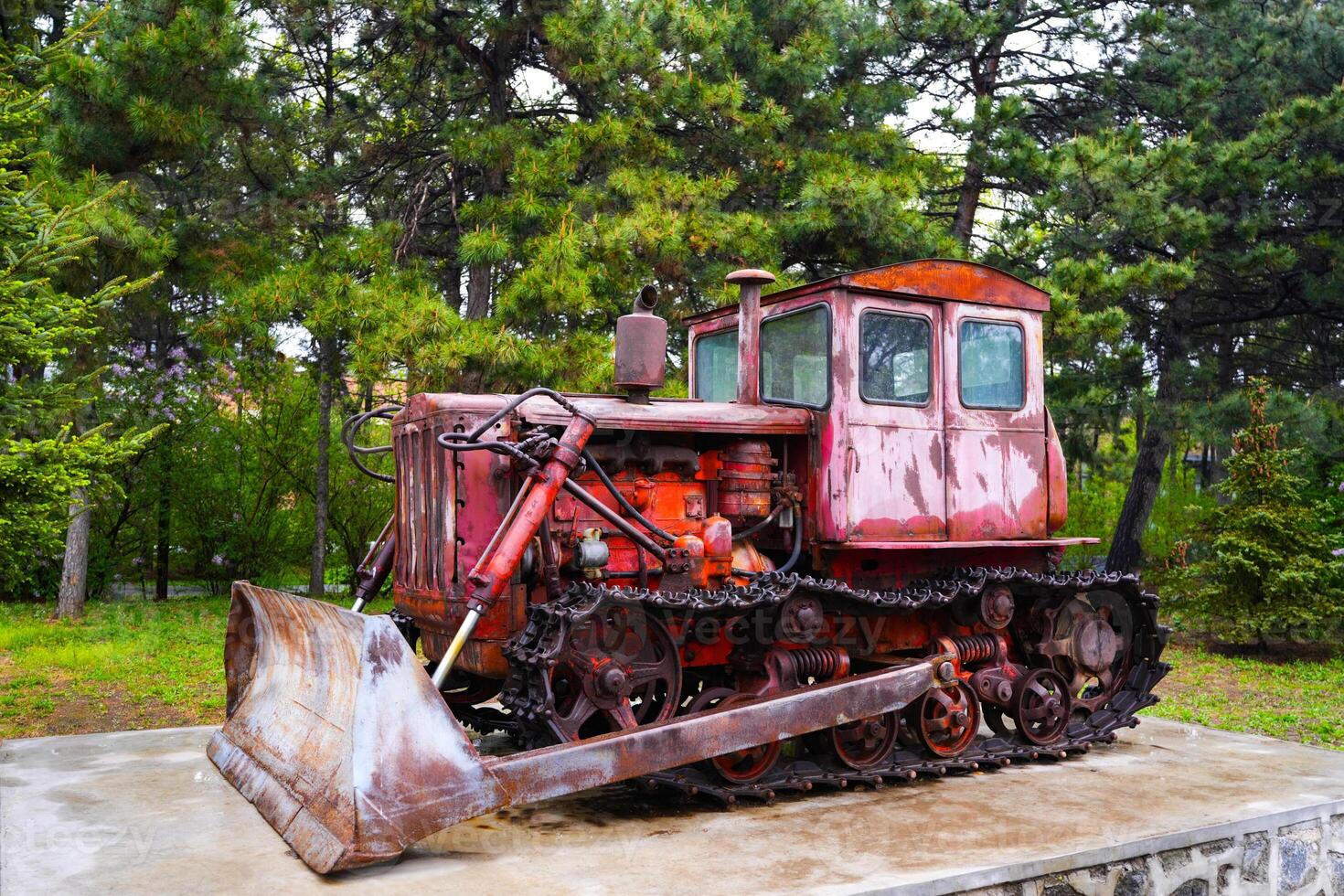 An old rusty tractor stands near the barn photo