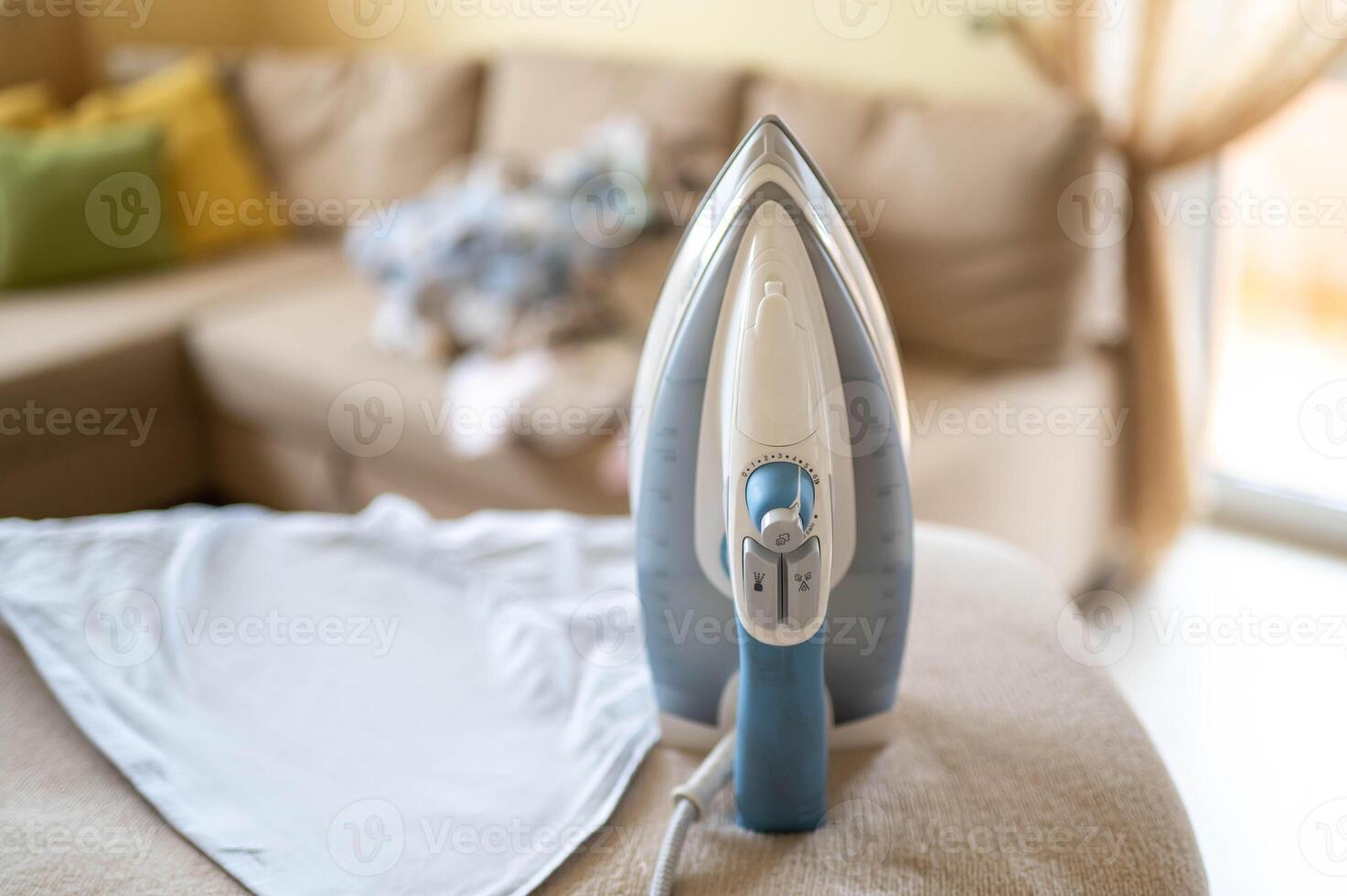 A close up of a iron sitting on a couch photo