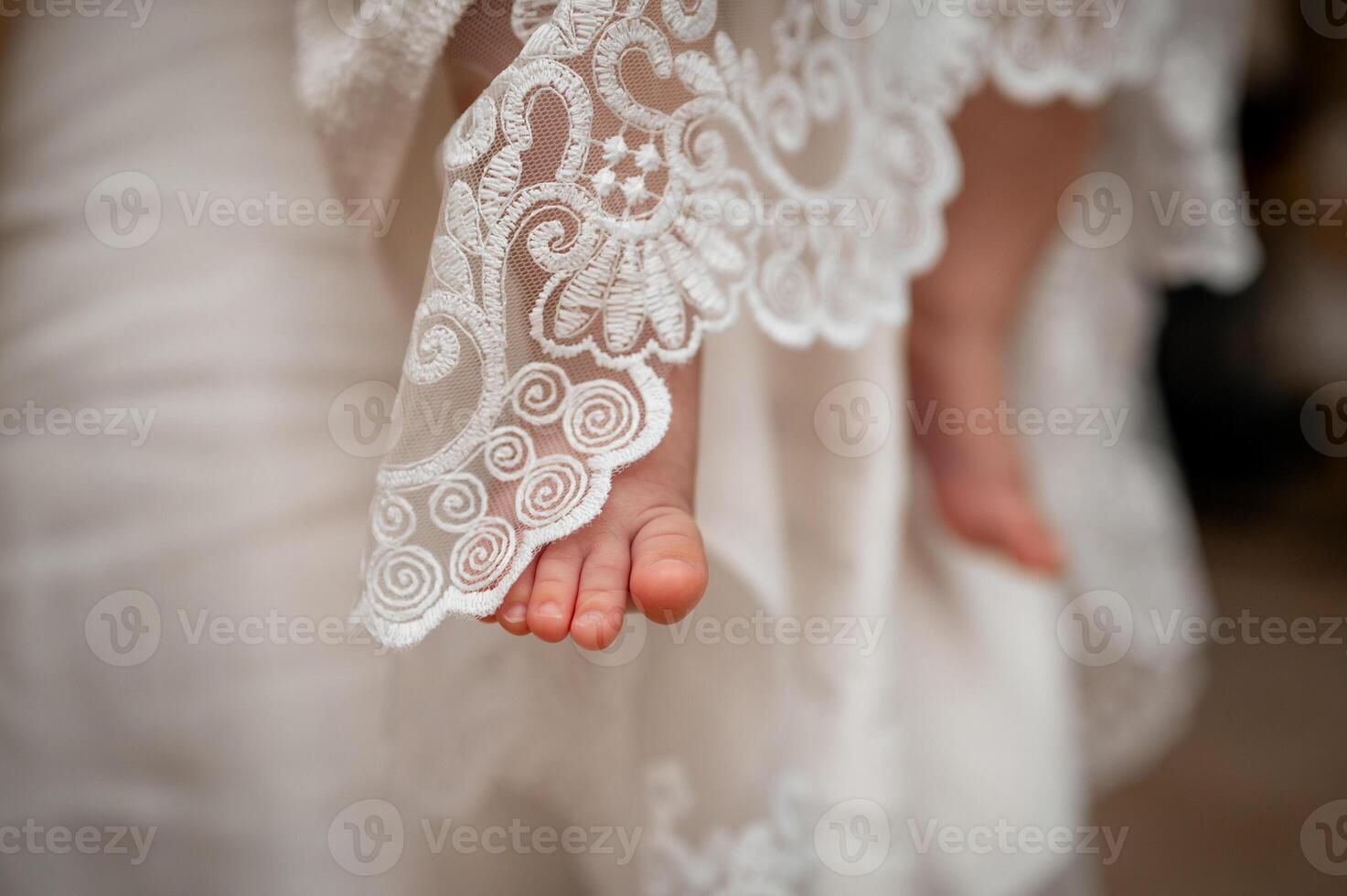 A close up of a bride's feet in a wedding dress photo