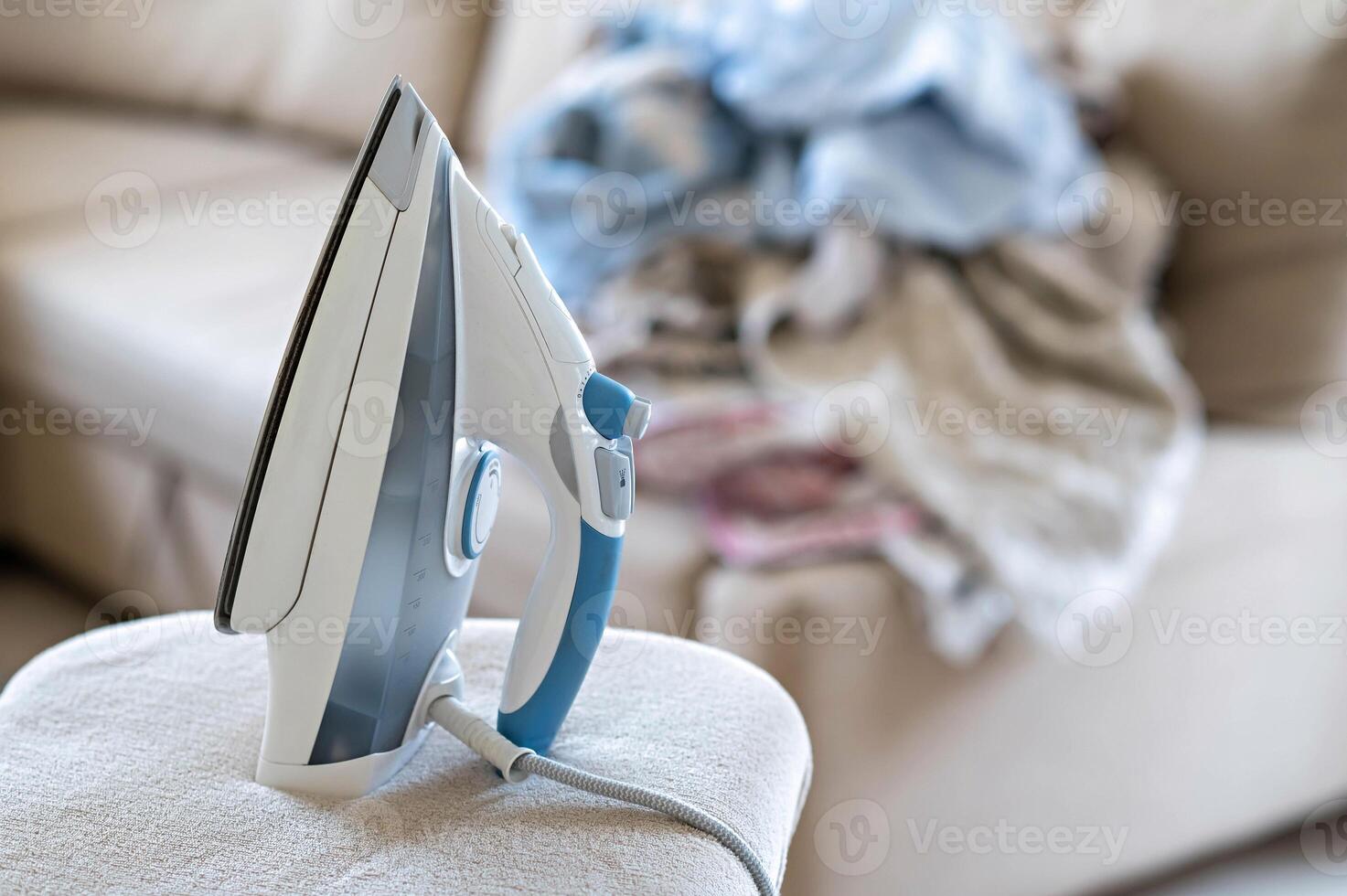 A white and blue iron on a couch photo