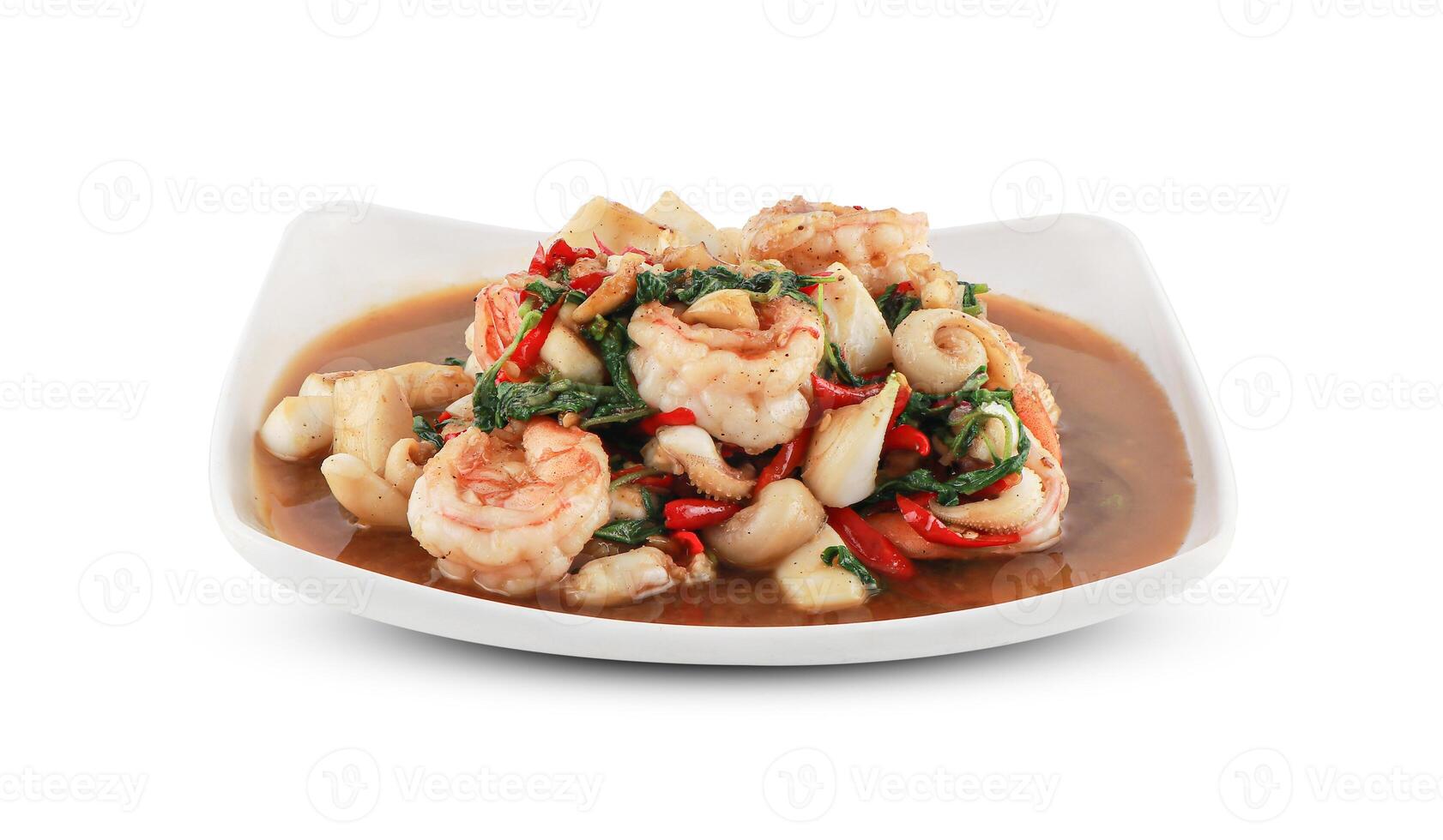 Stir fried mixed seafood shrimp and squid with holy basil Served in a white plate isolated on white background with clipping path, Thai Food. photo