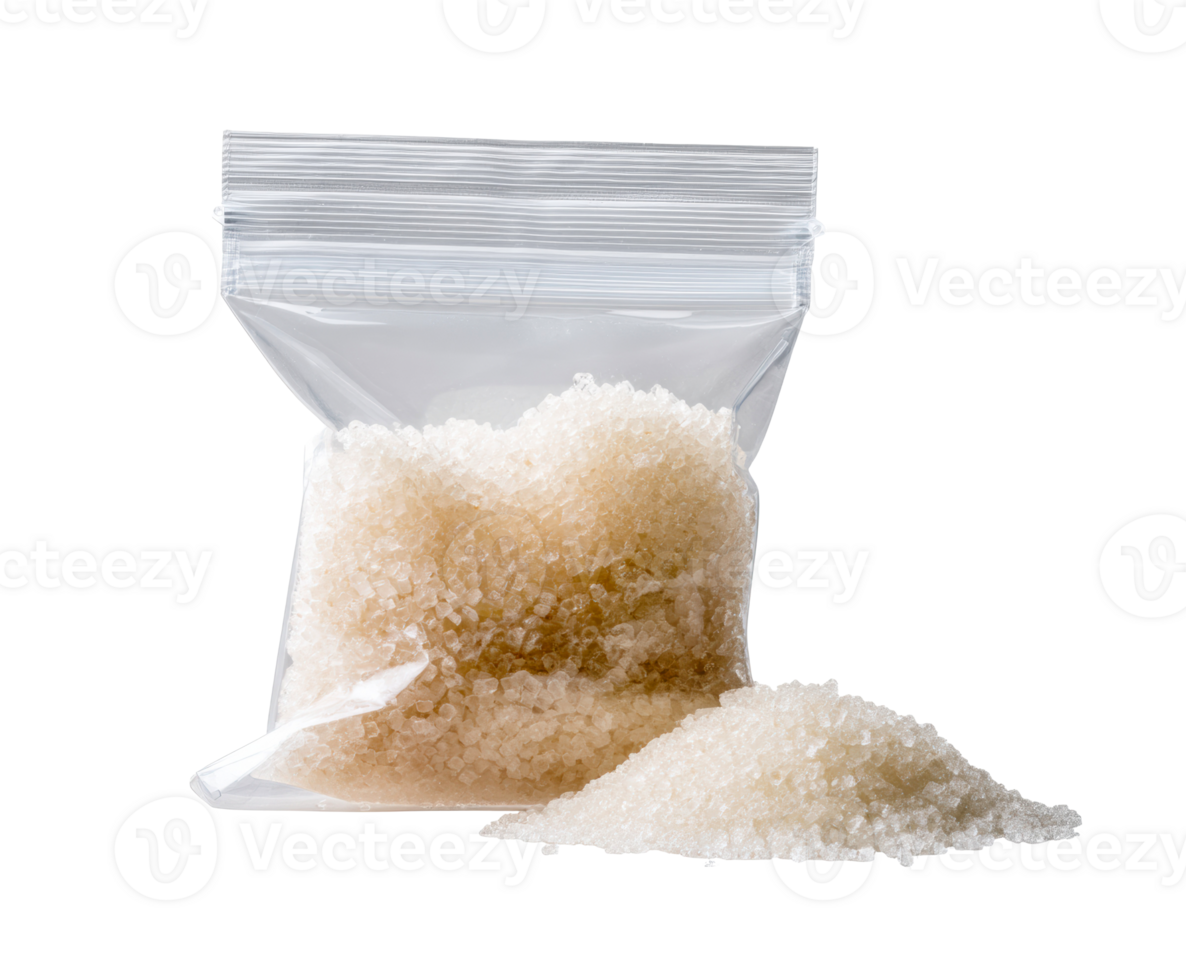 White sugar in a sealed bag with loose granules on the table png