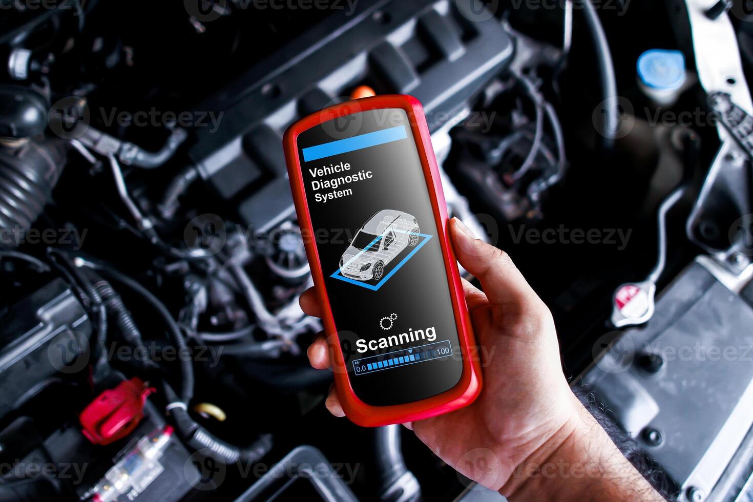 Vehicle Diagnostics Wireless Tool, A handheld device OBD2 scanner diagnostic for car repair by technician in auto service garage. photo