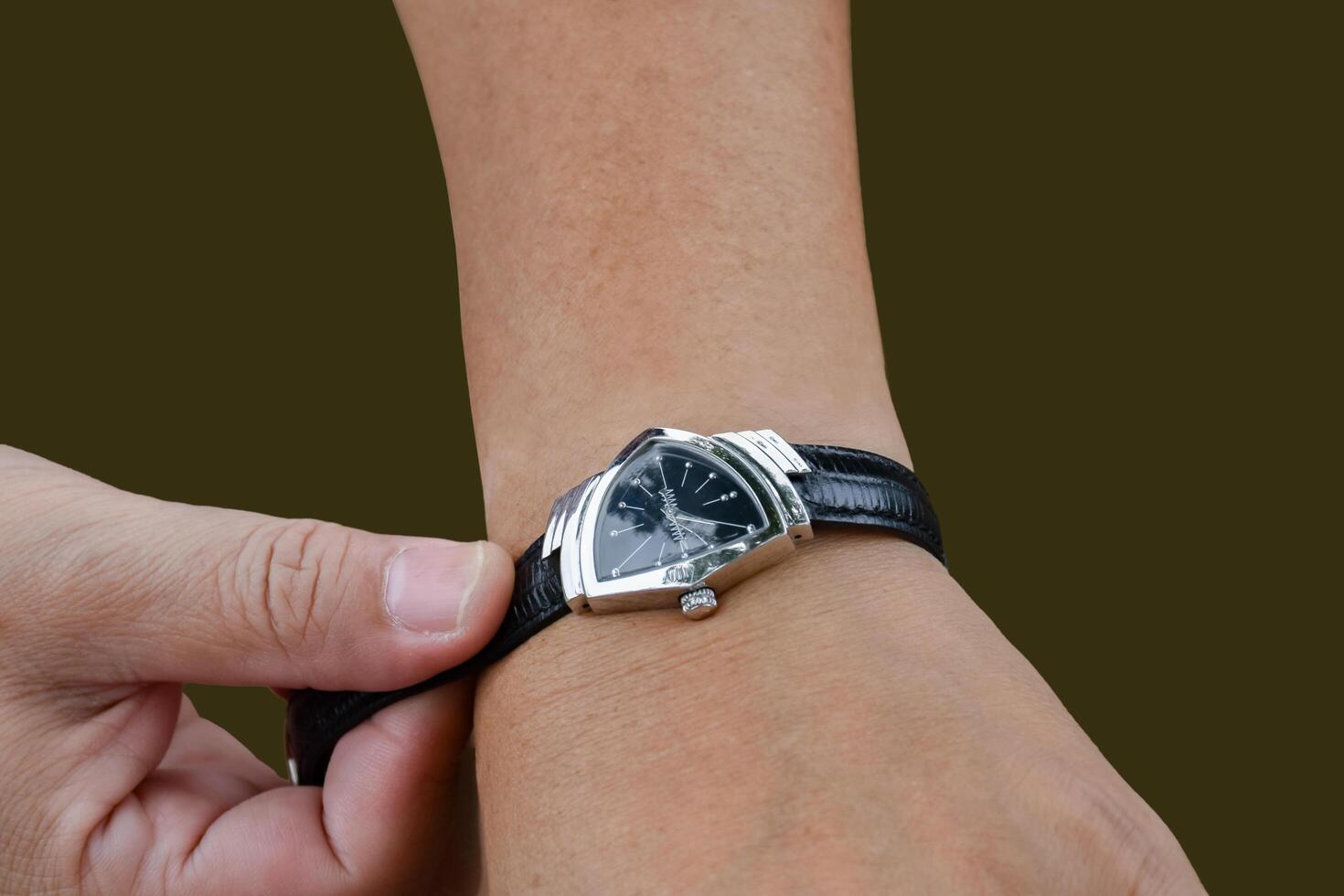 Isolated hand wearing watch of woman with clipping paths. photo