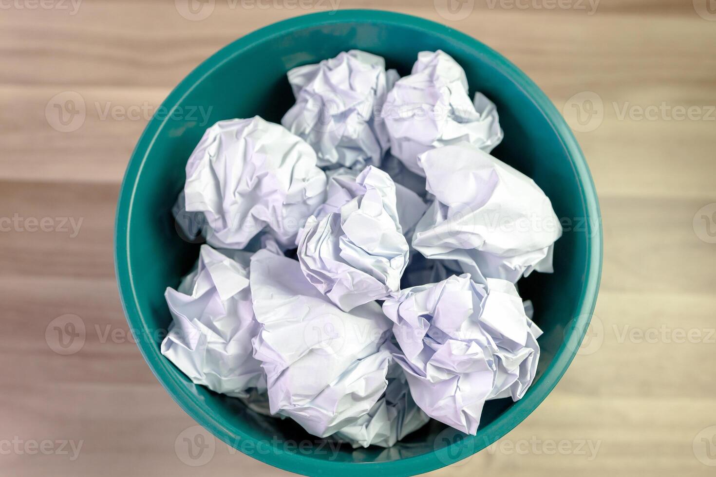 crumpled paper ball in trash can, paper waste, trash bin in office with crumple paper ball, work hard ideas concept photo