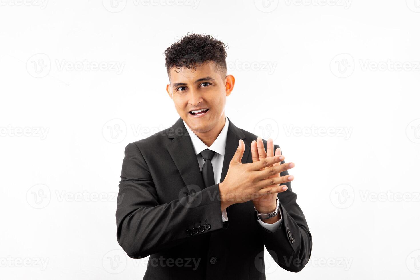 Portrait of a man wearing business suite clapping and applauding happy and joyful, smiling proud hands together. photo