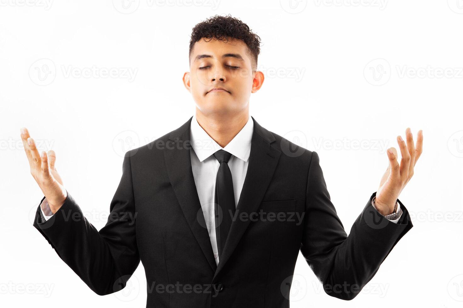 Handsome young man wearing business suite relax and smiling with eyes closed doing meditation gesture with fingers. yoga concept. photo