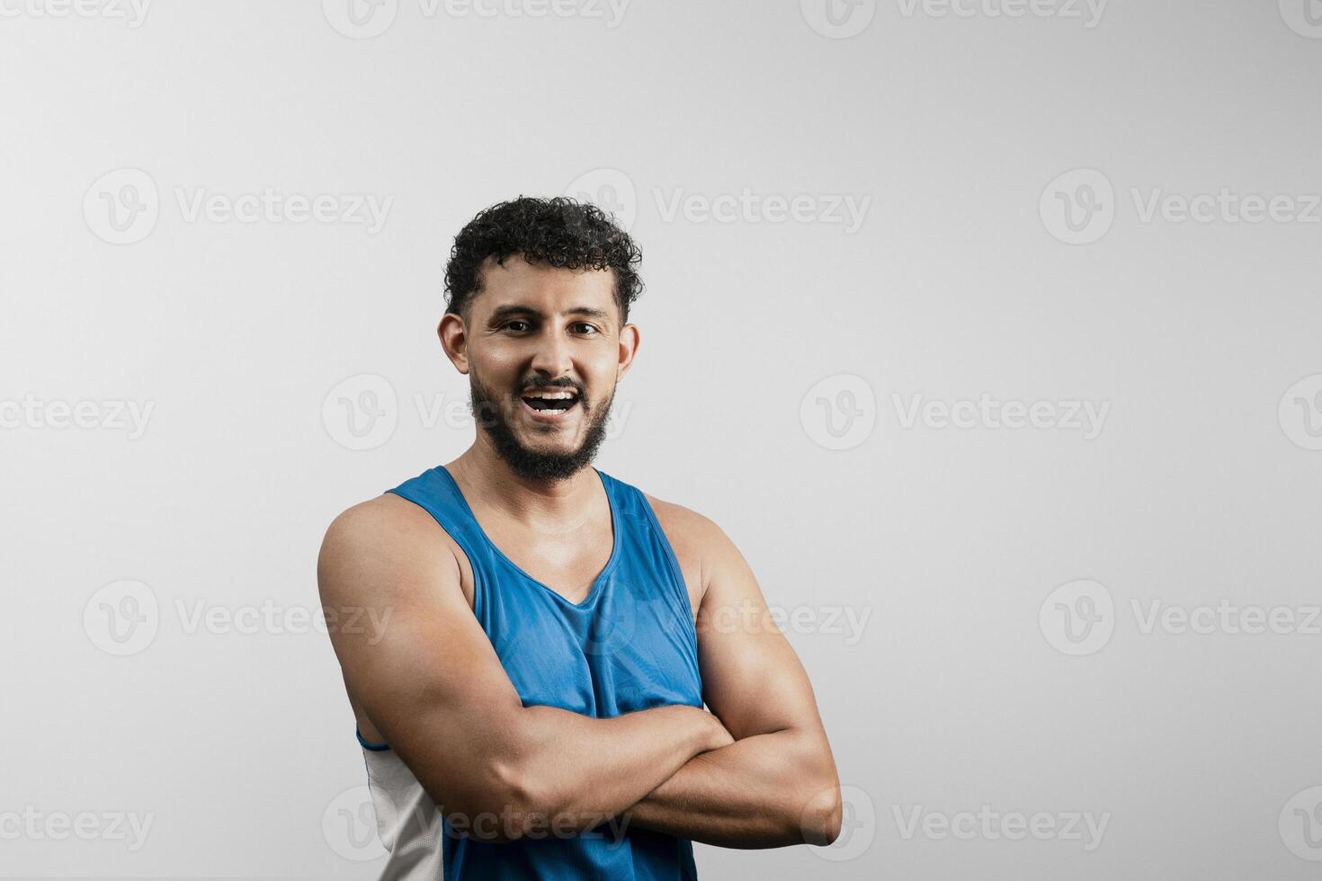 Strong hispanic man smiling and showing muscle growth progress photo