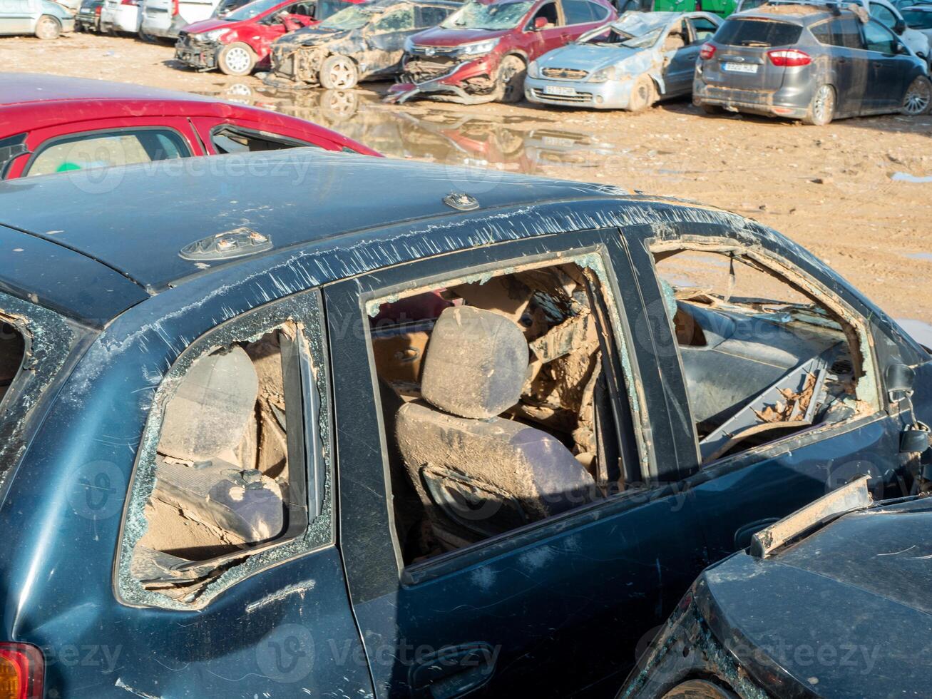 ruined, muddy vehicle captured after severe flood, representing vulnerability and environmental consequences of natural disasters photo