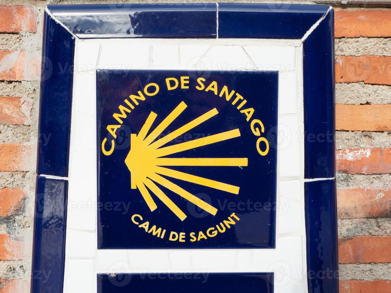 Camino de Santiago sign mounted on an old brick wall in the historic city of Sagunto, Valencia, Spain. Ideal for travel guides, history blogs and cultural publications photo